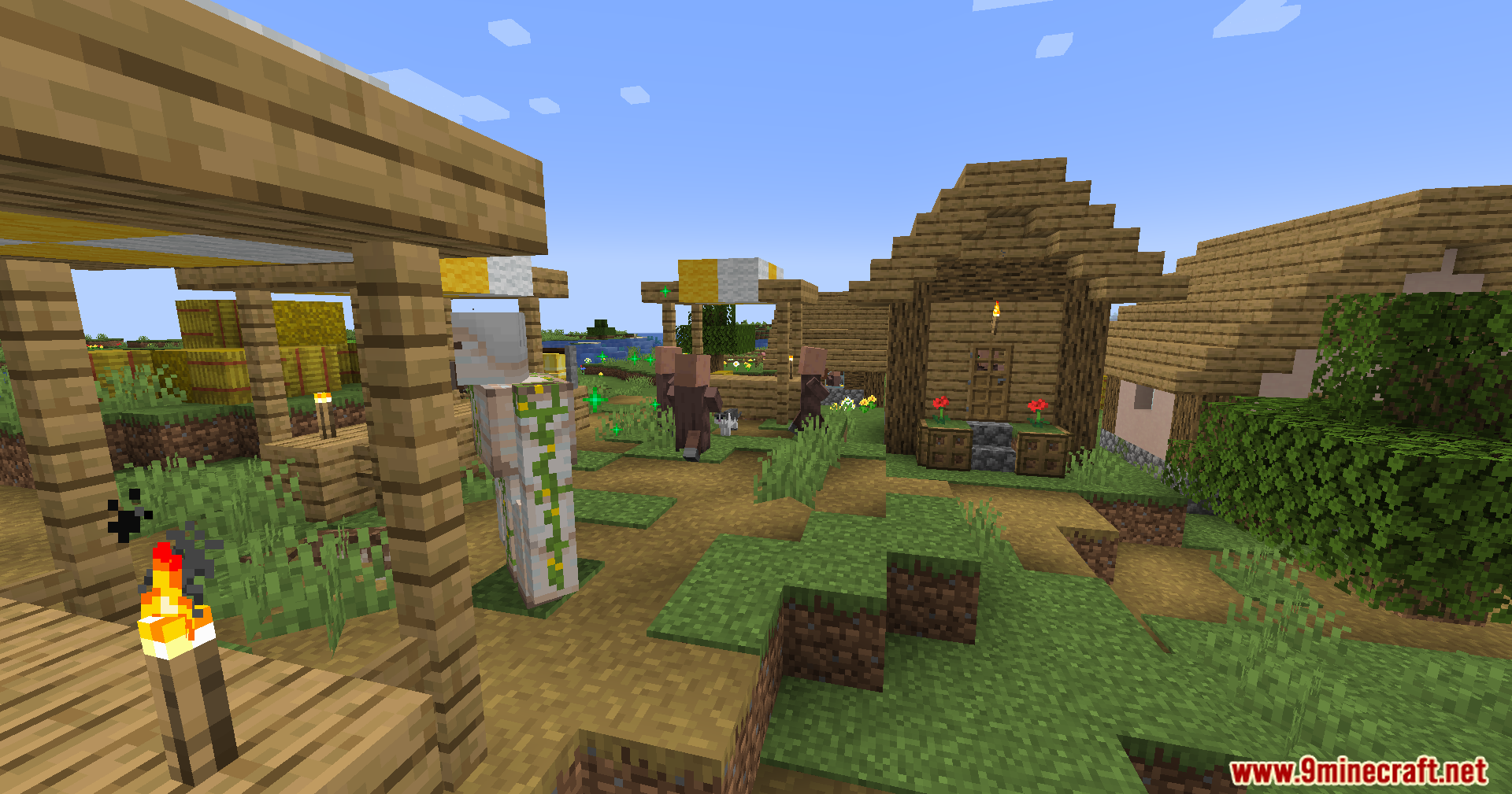 Villagers and an iron golem in a sunny village
