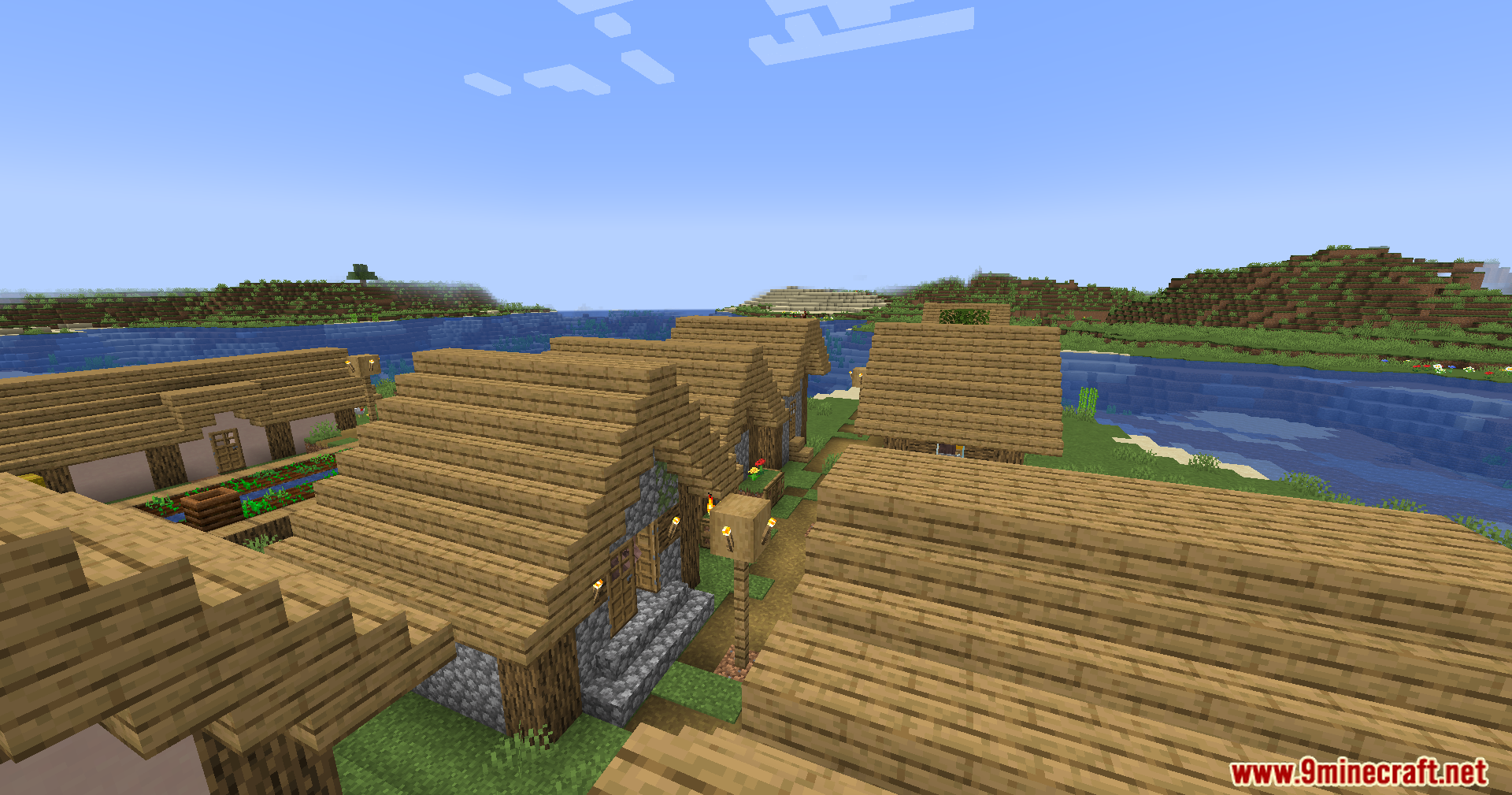 A peaceful village landscape with wooden houses and farms