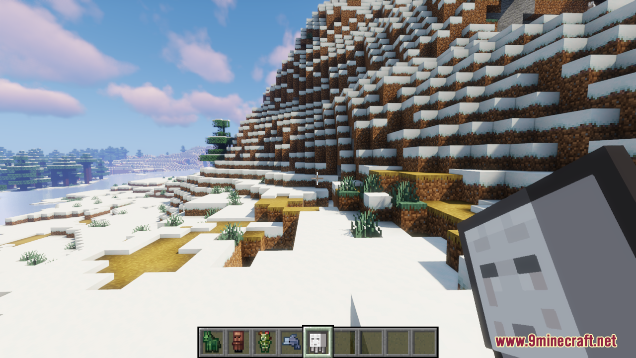 Player holding a tiny ghast spawn egg near a snowy mountain area