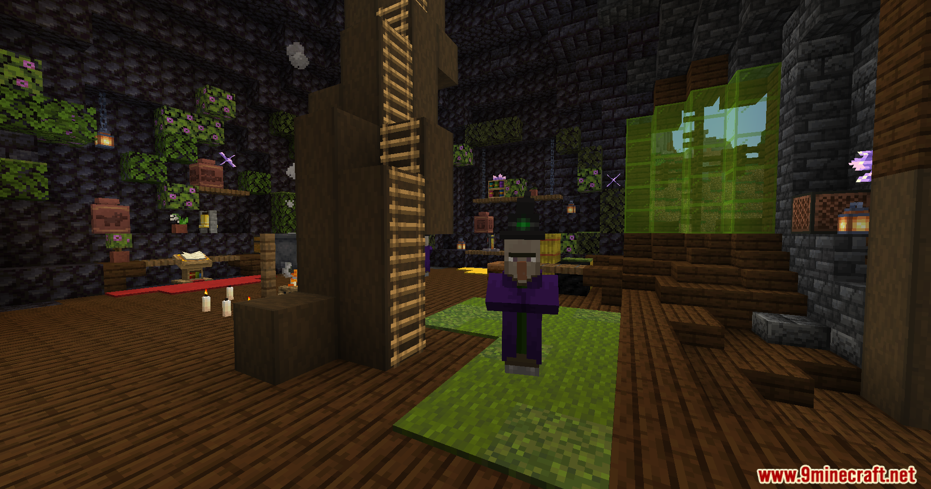 A witch stands guard inside the giant cauldron structure