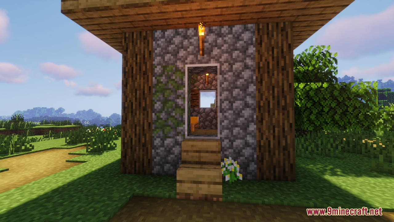 Cobblestone building entrance featuring tall clear glass panes installed