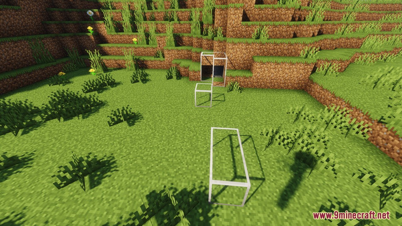 Several transparent glass blocks and panes scattered on the grassy terrain