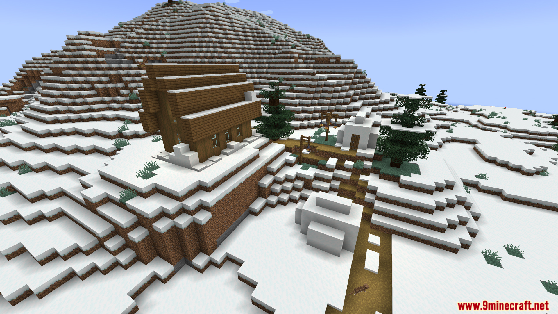 A snowy village built on a large mountain slope