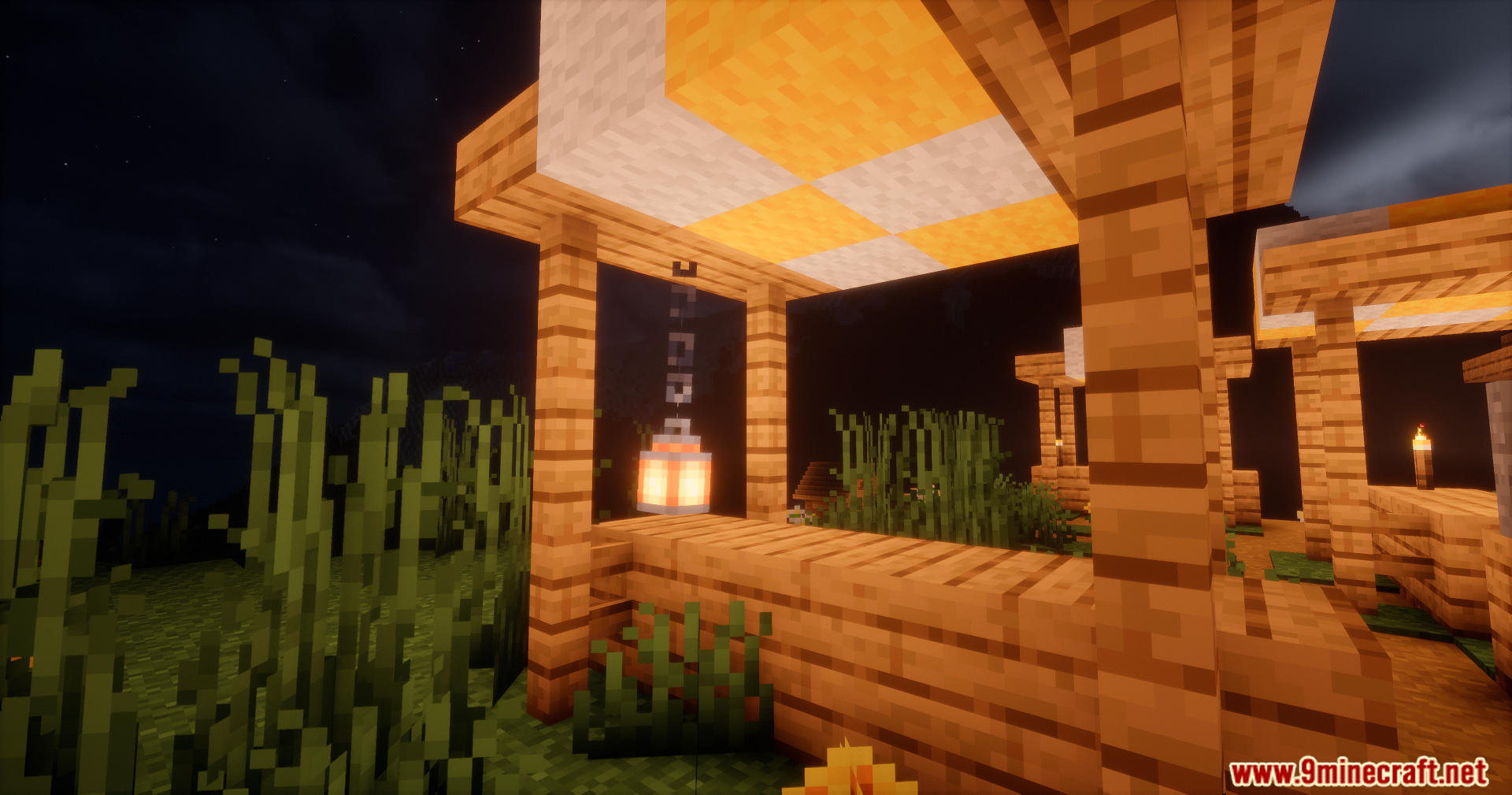 A glowing lantern hanging under a wooden roof at night