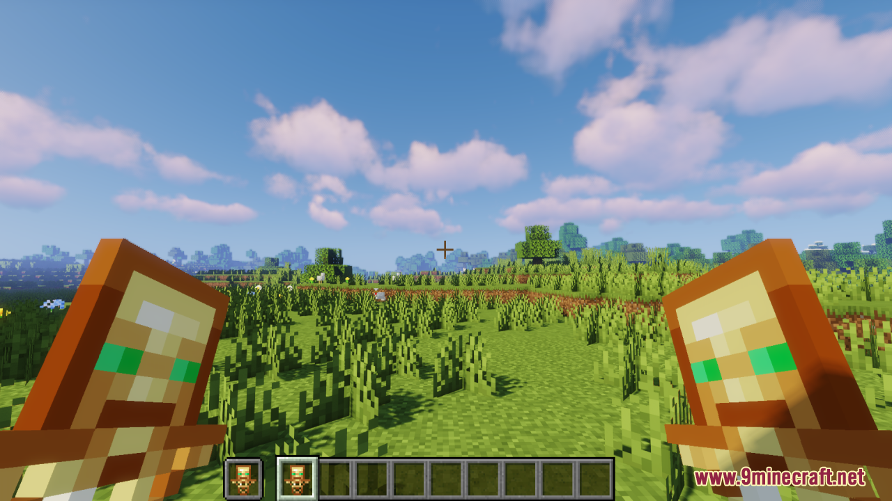 Player holding two Totems of Undying in a grassy field