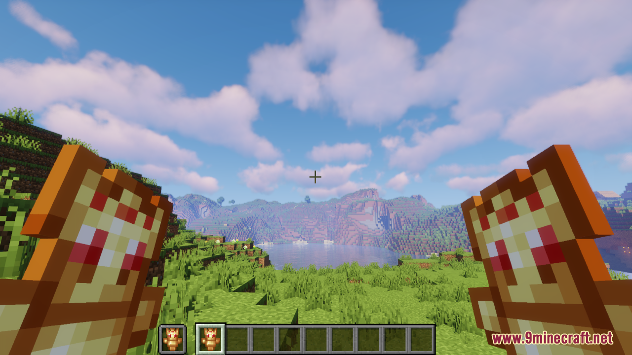 Player holding two Technoblade Totems in a grassy mountain landscape