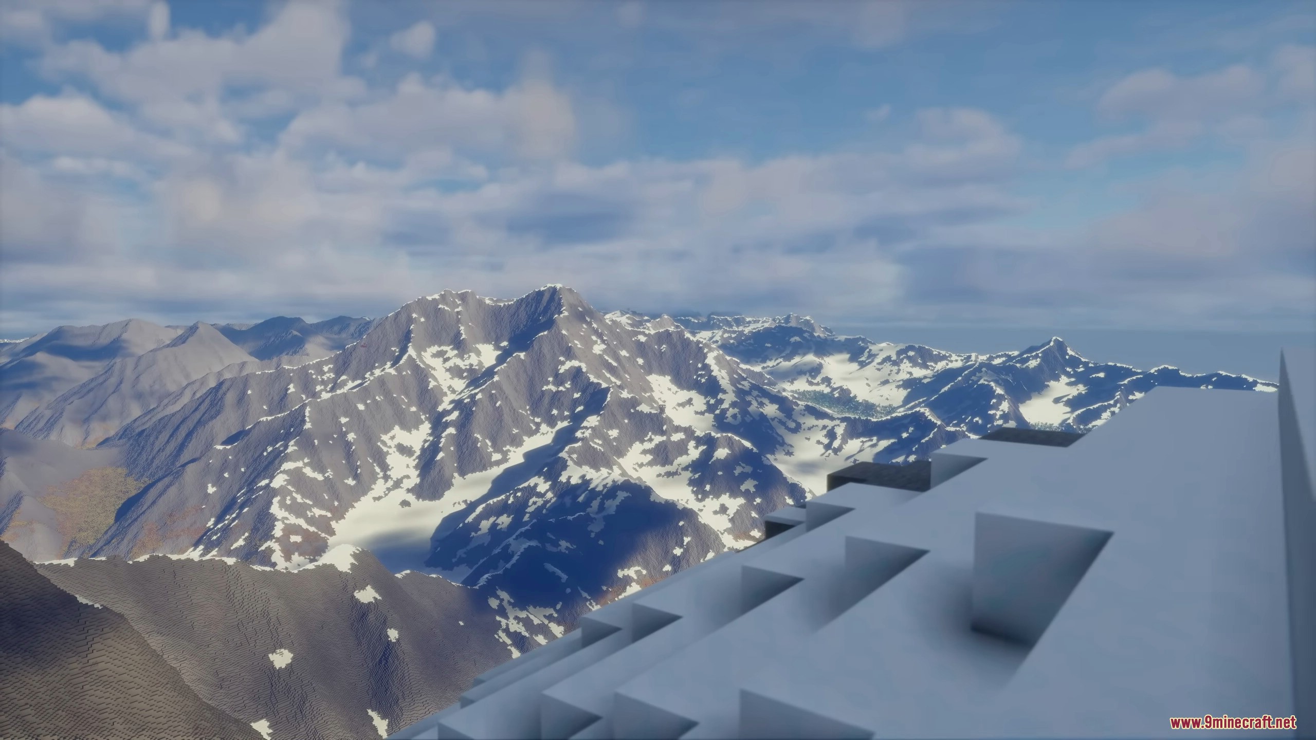 Aerial view of massive snow capped mountain peaks