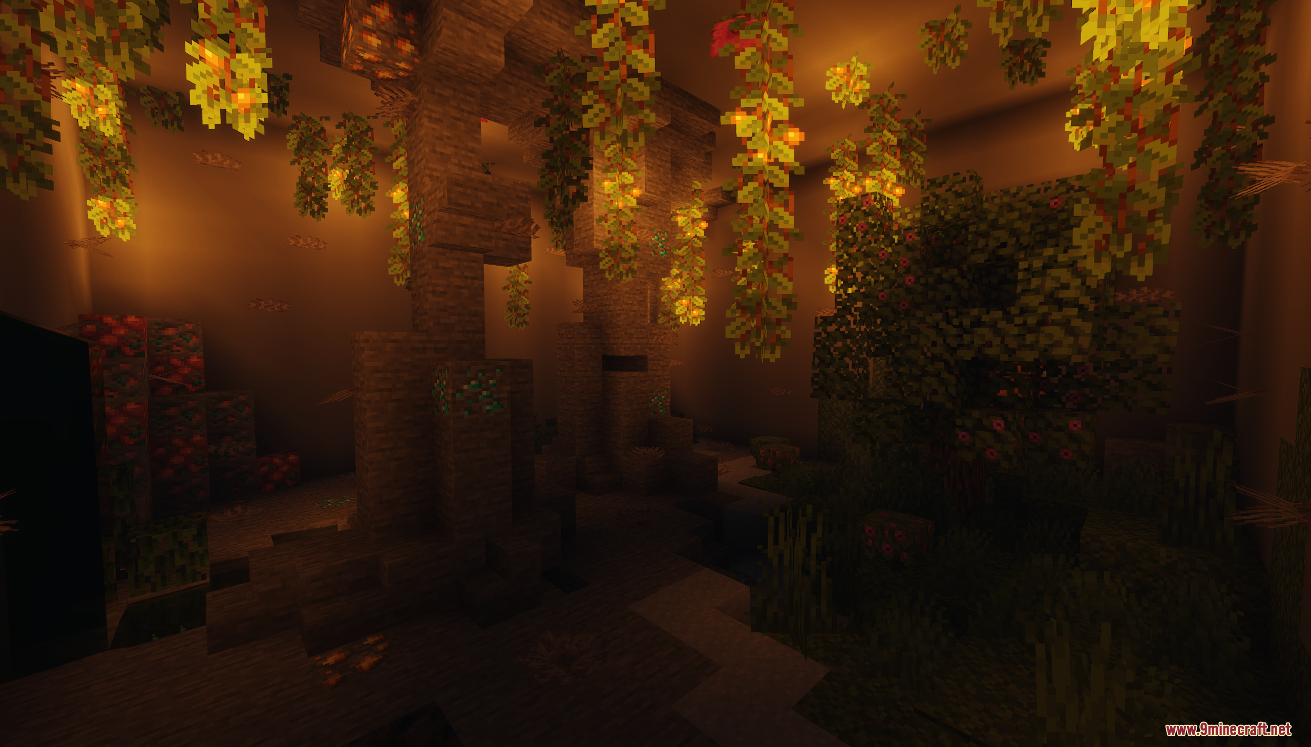 An overgrown underground cave with glowing hanging vines