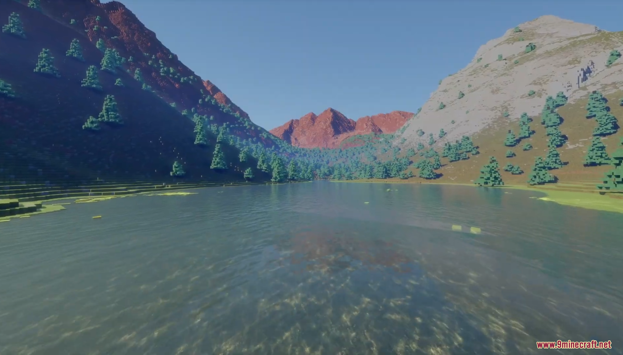 Scenic view of Crater Lake surrounded by red mountain peaks