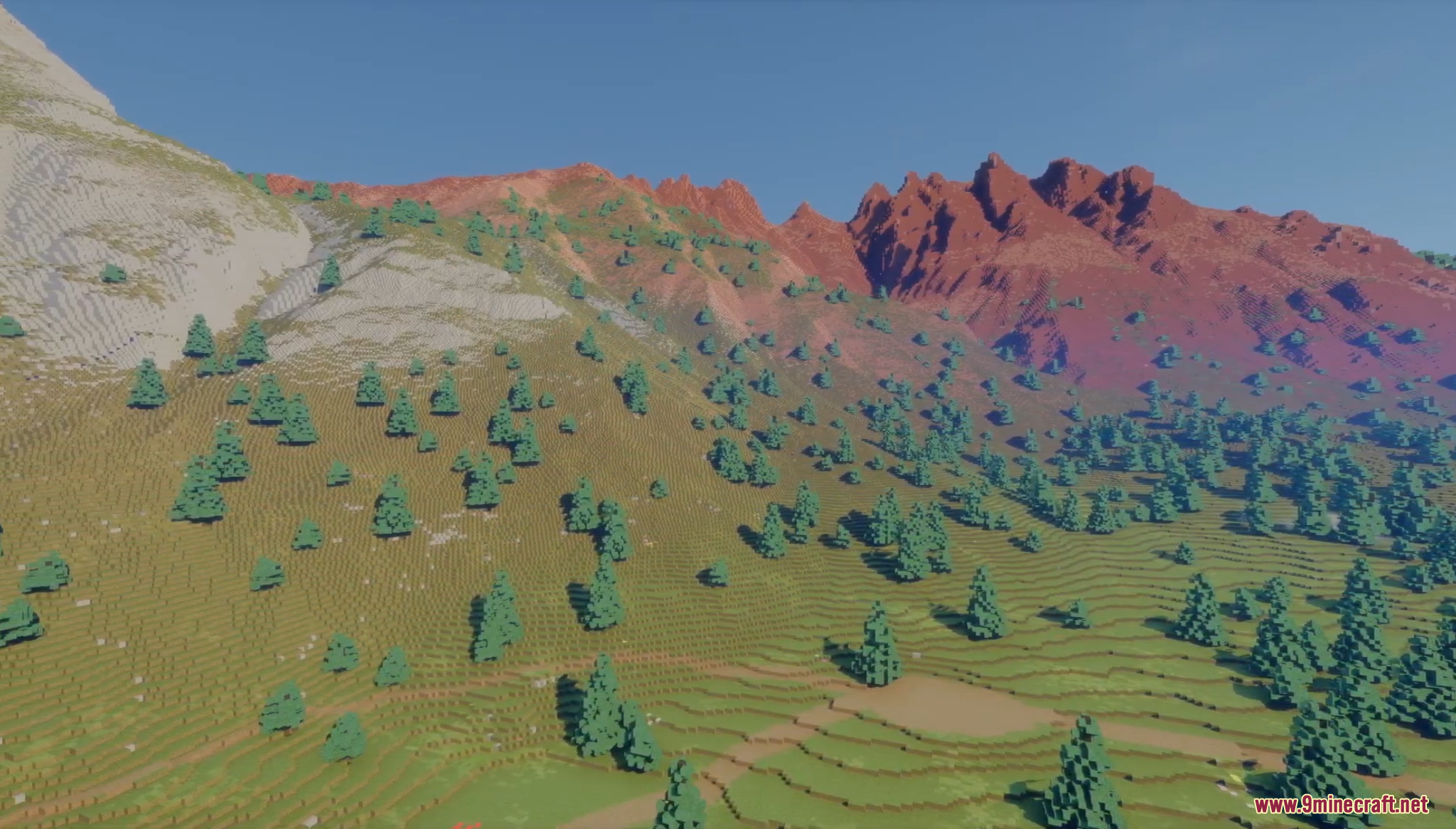 Walking along a grassy hillside trail with scattered pine trees