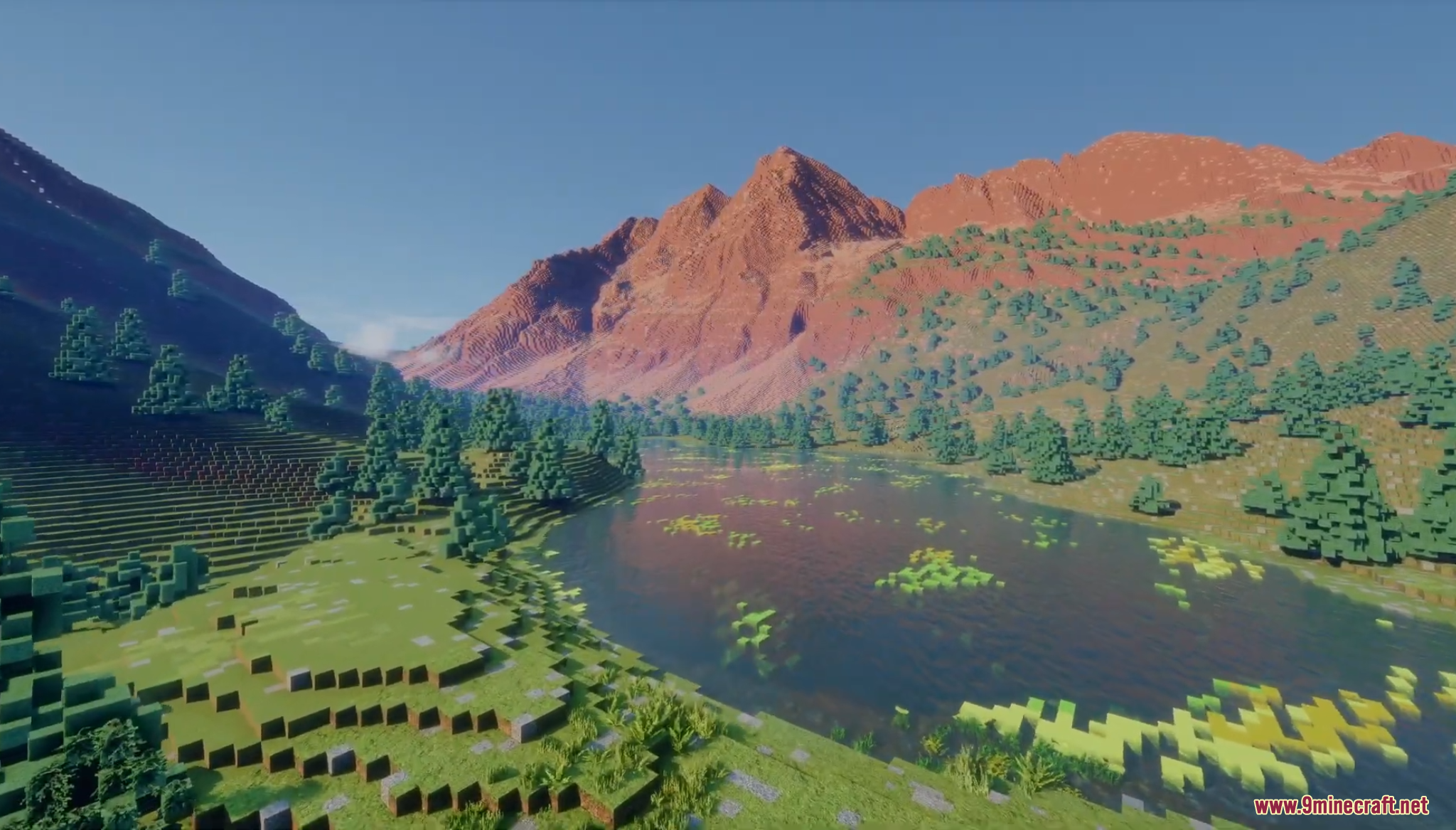 Scenic alpine lake surrounded by pine trees and tall reddish mountains