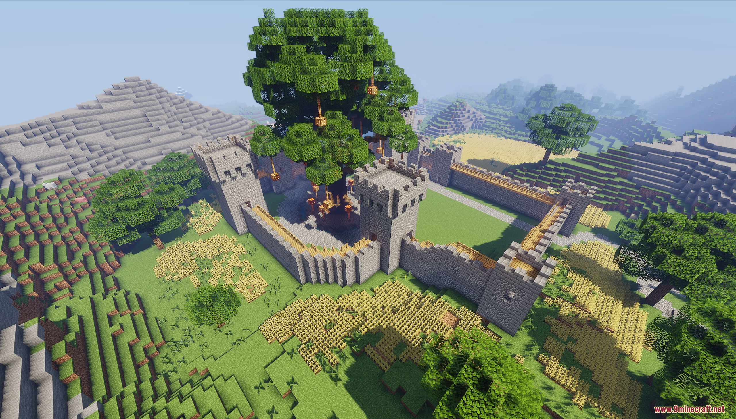 Aerial view of a castle surrounding a giant central tree