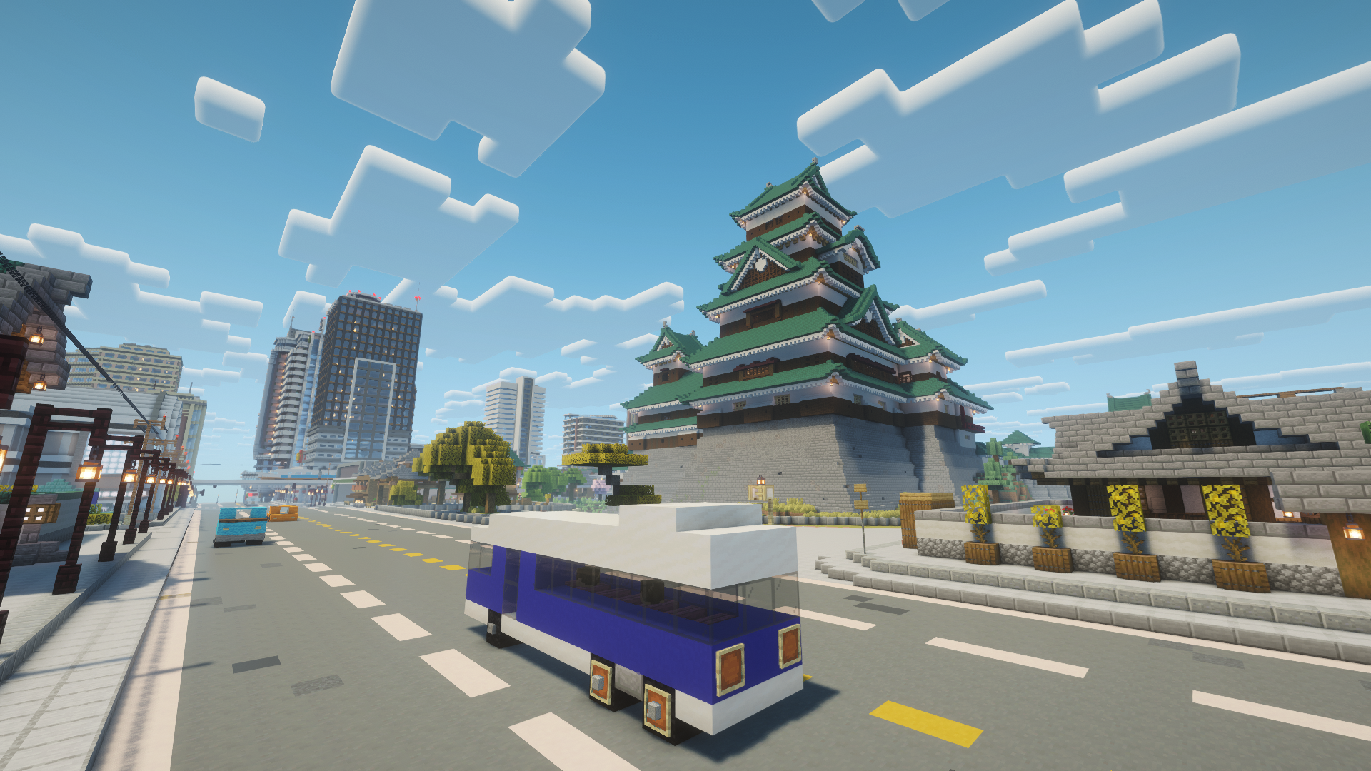 Blue bus driving past a traditional Japanese castle and modern skyscrapers