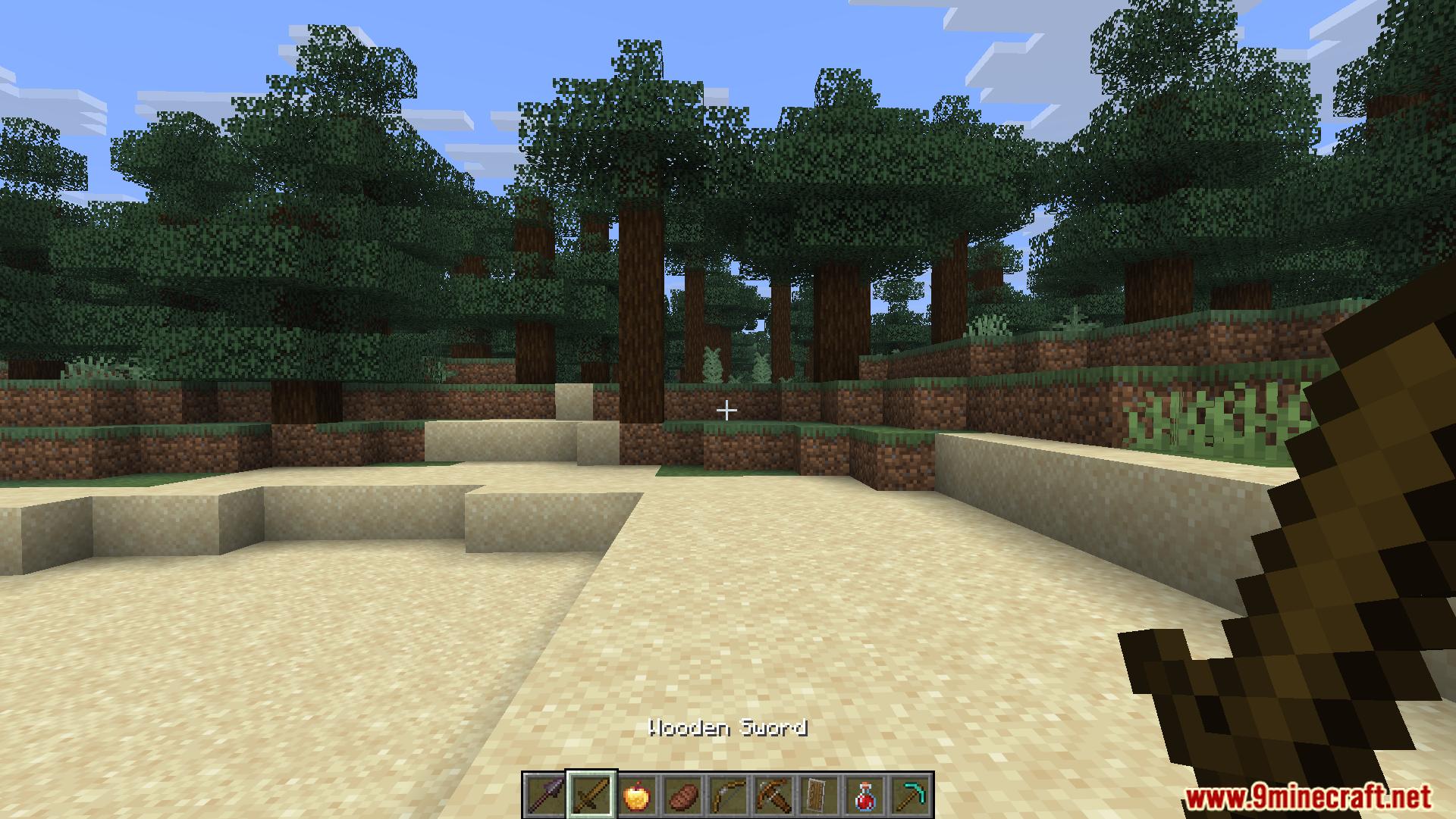 Player holding a wooden sword in a grassy forest area