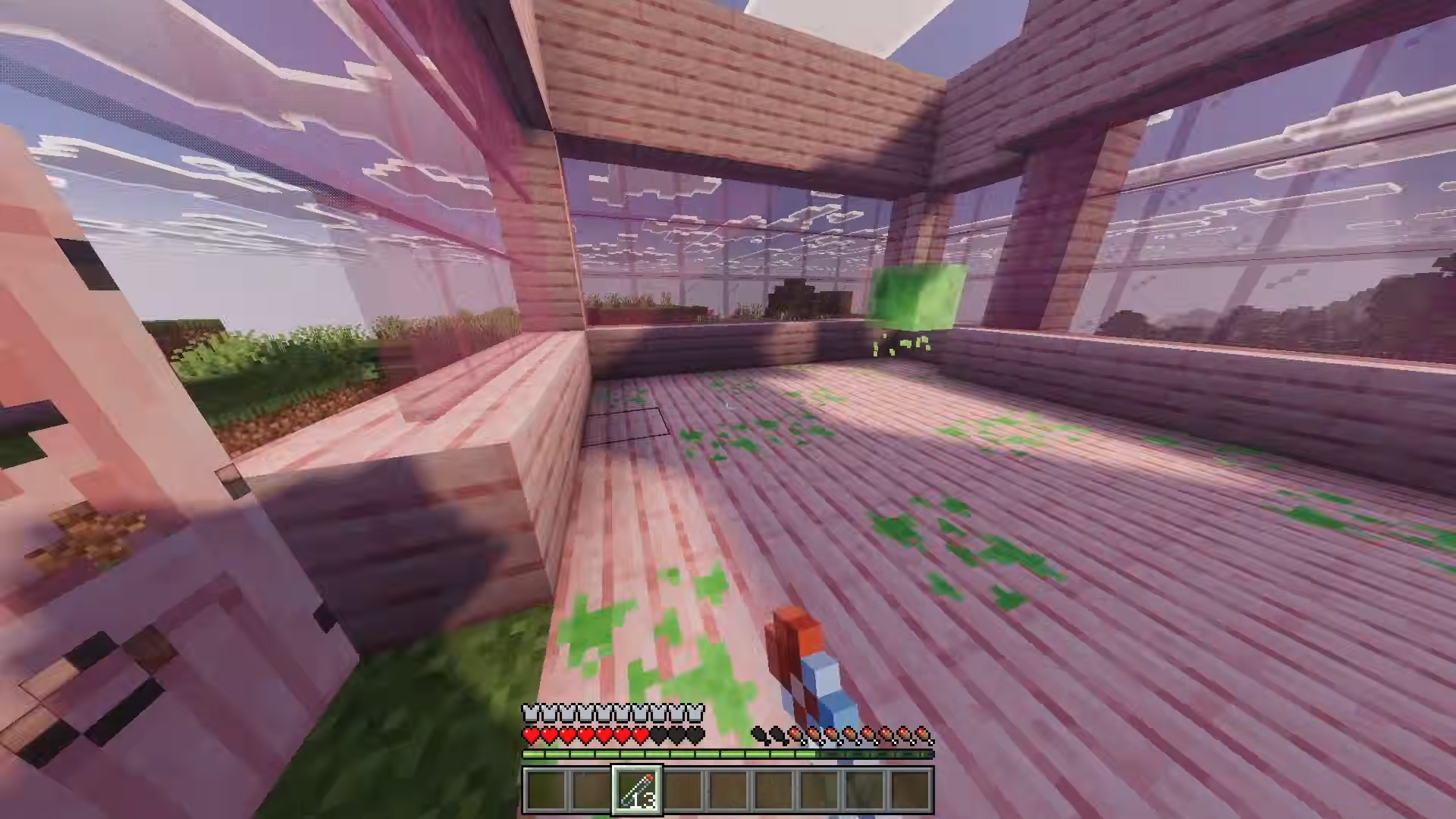 Player holding slime sling inside wooden room with a green slime