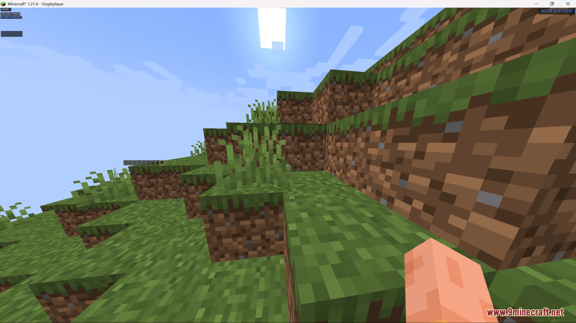 First person view of grassy hills and a blue sky