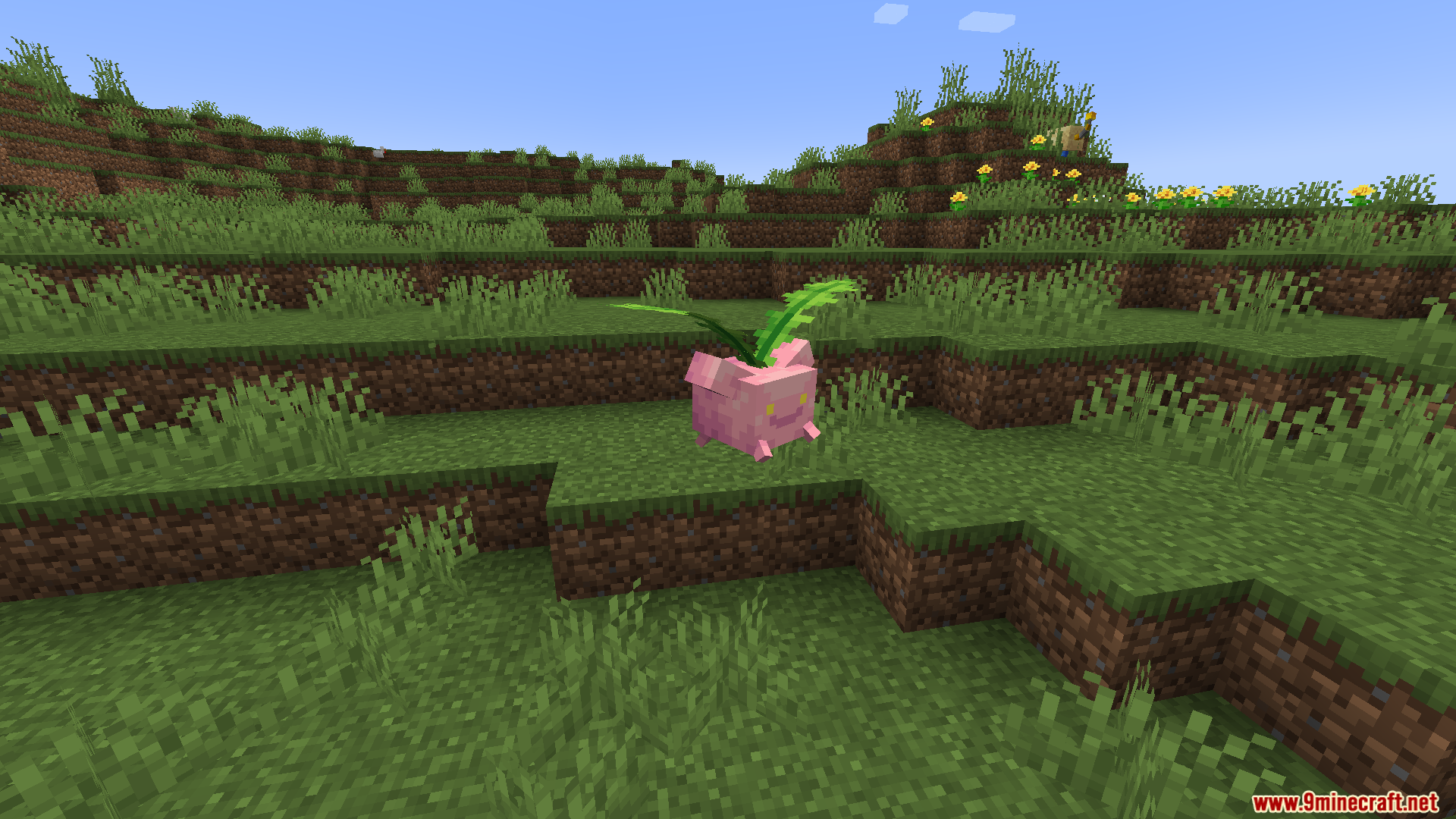Pink Hoppip Pokemon resting in a grassy field with yellow flowers