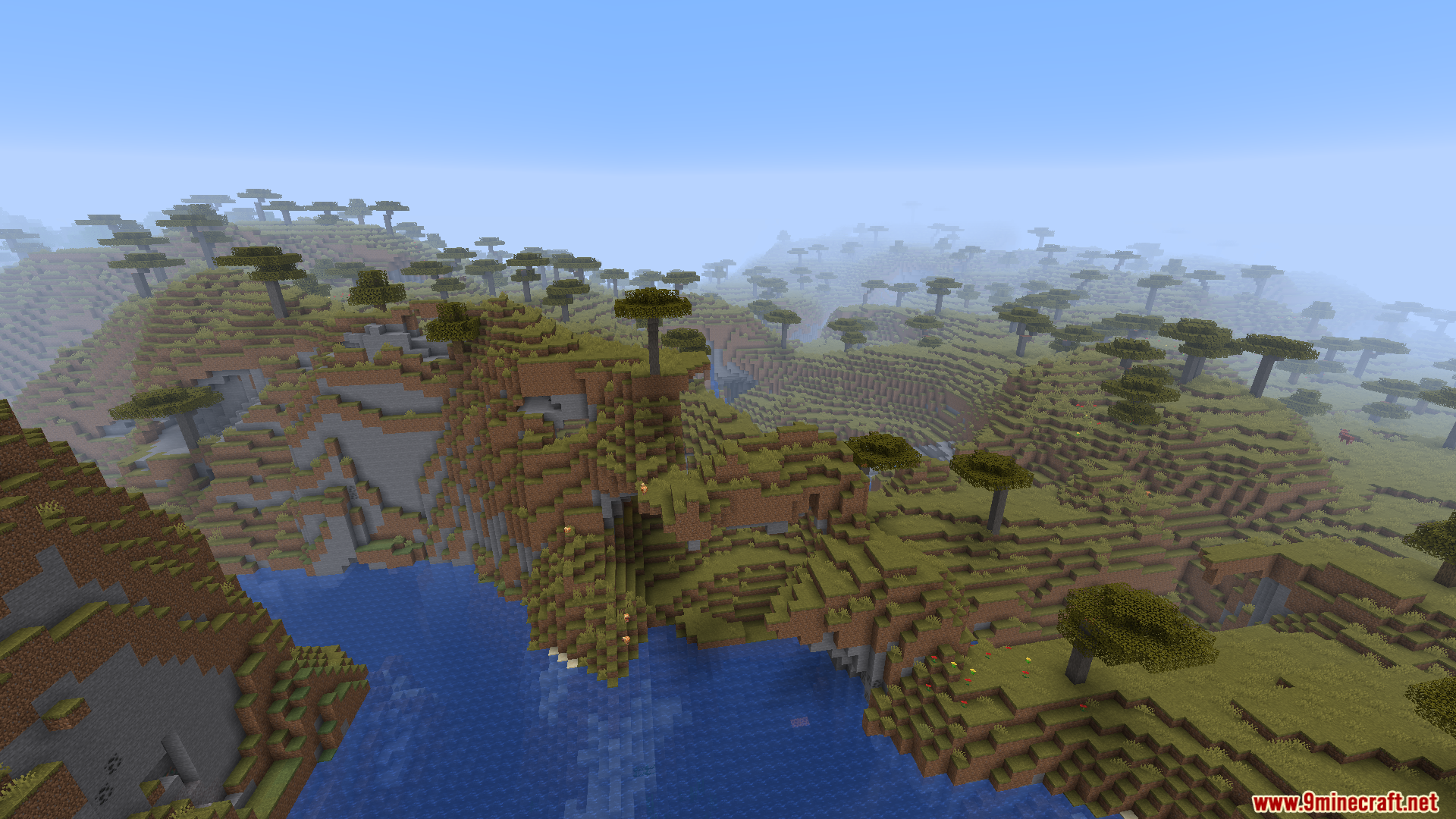 WorldWeaver Neoforge Mod Screenshot 4 Aerial view of savanna terrain with river and cliffs