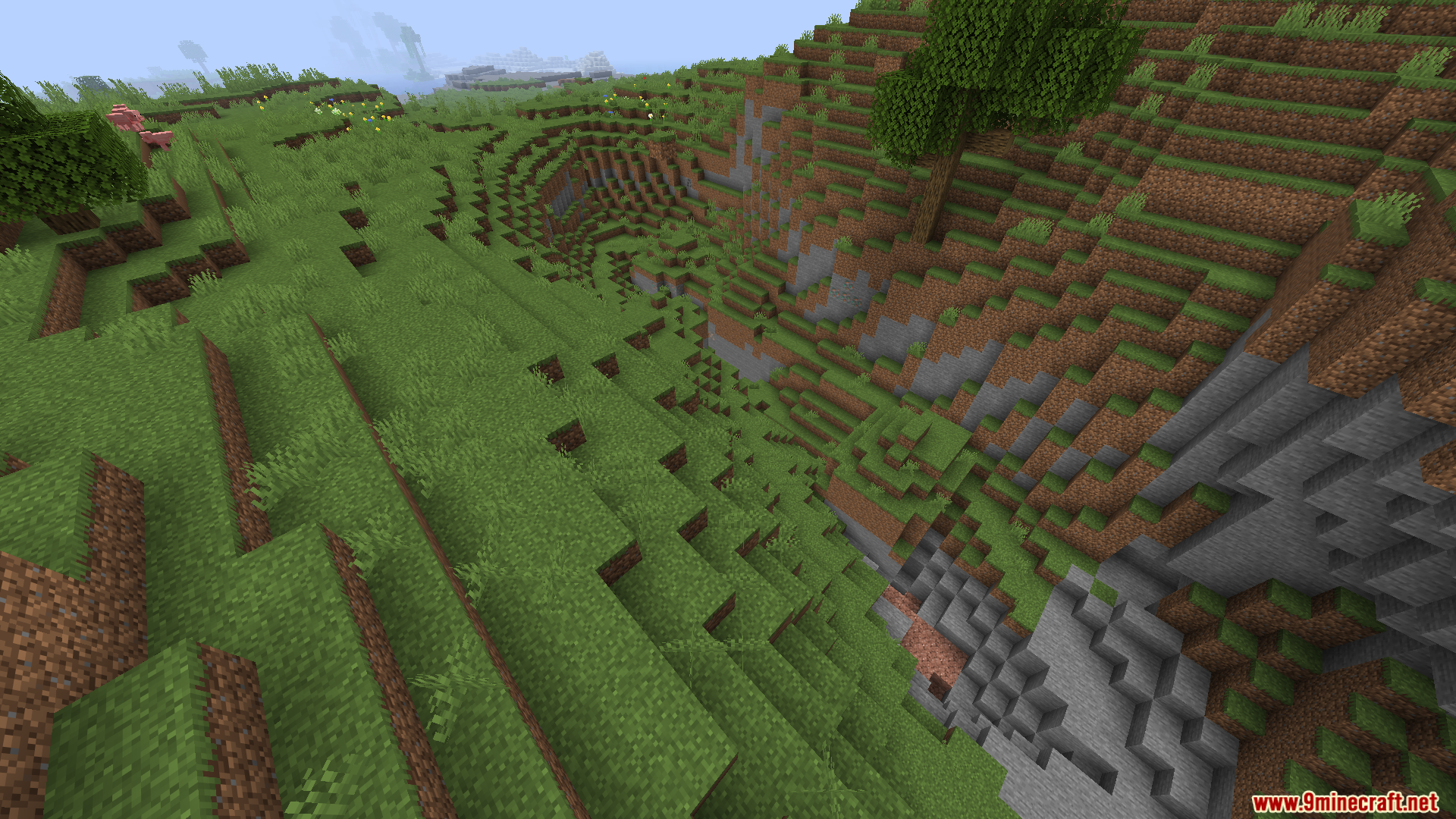 WorldWeaver Neoforge Mod Screenshot 8 Steep grassy ravine showing natural terrain generation and stone layers