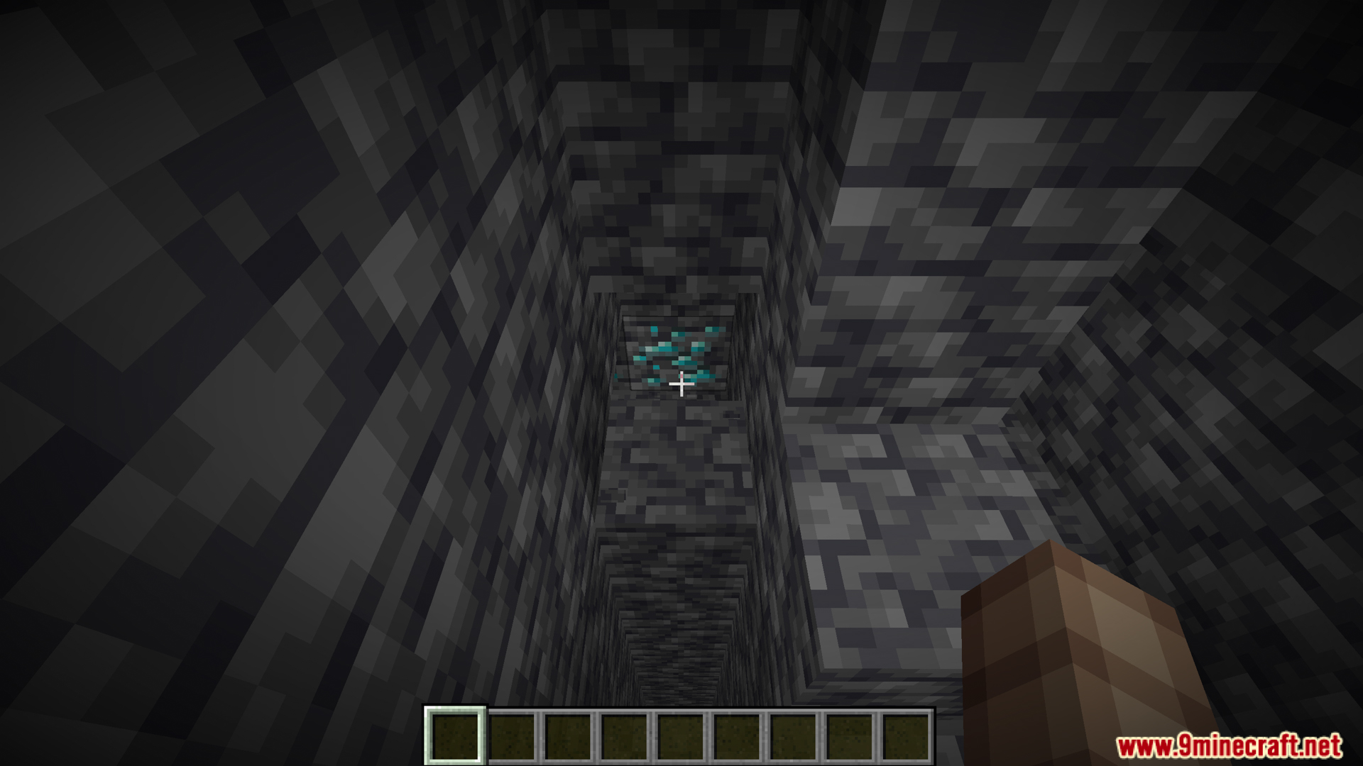 Player spotting diamond ore while looking down a deep mining shaft