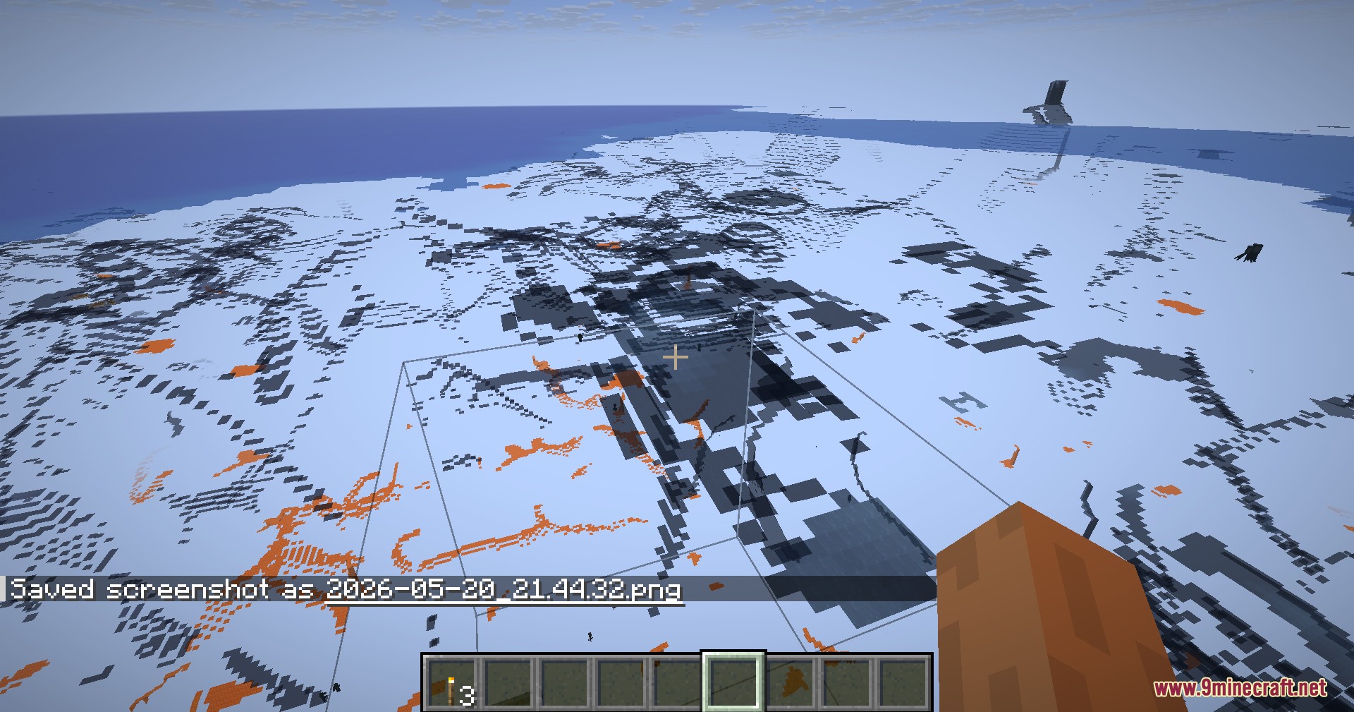 Player holding sand block while using x ray to view underground lava pools