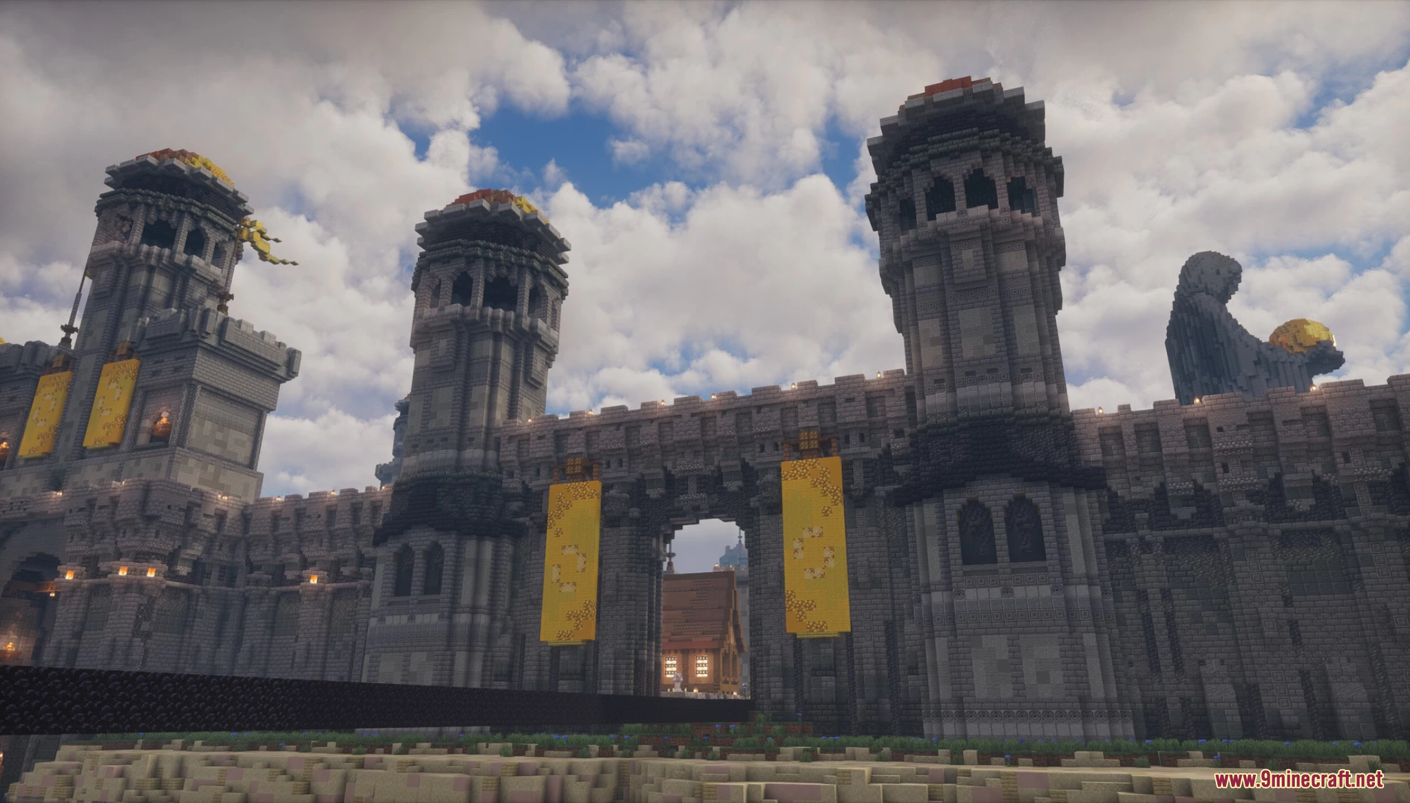 A massive stone castle gatehouse with tall, ornate towers