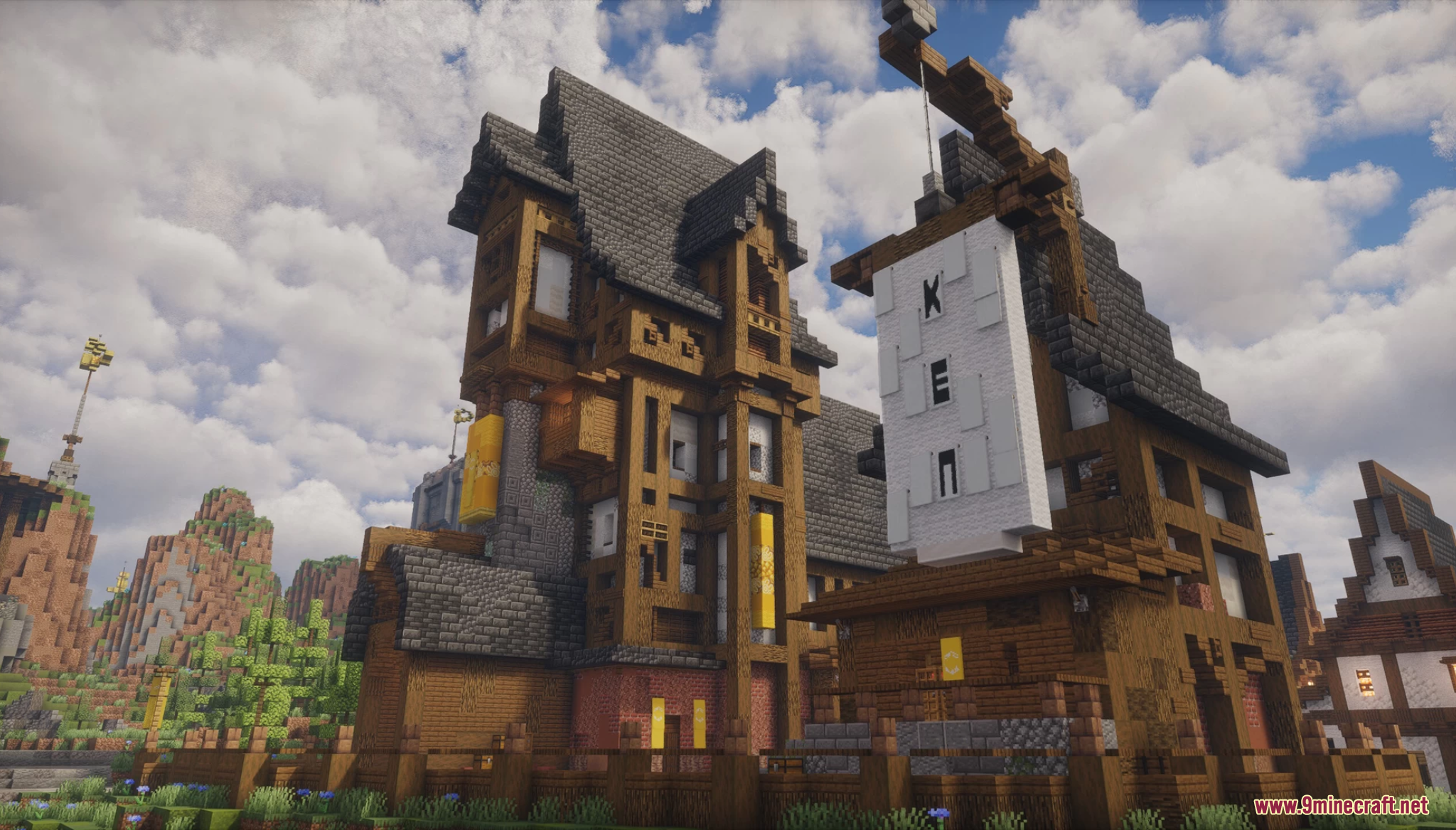 Tall medieval timber-framed buildings with a large wooden crane