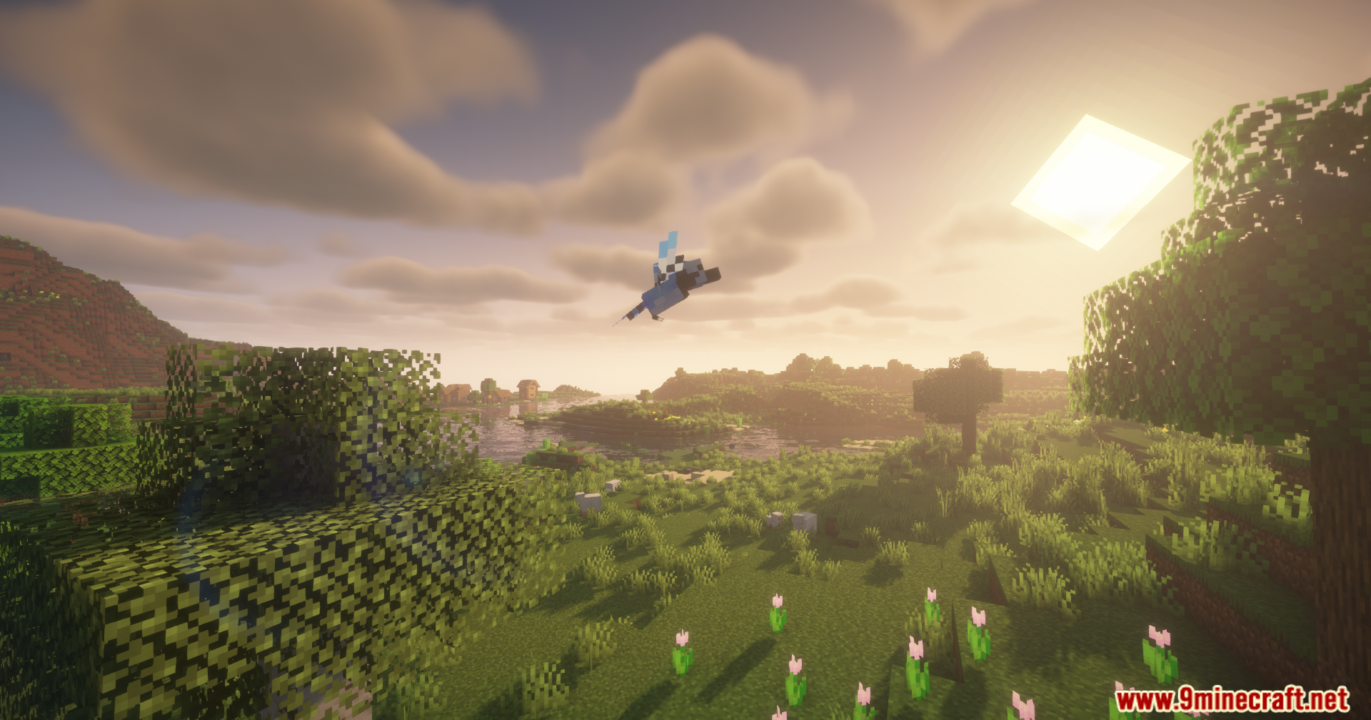 Alex's Mobs Unofficial Port Mod Screenshot 4 Small blue bird flying over a lush green landscape during the sunset