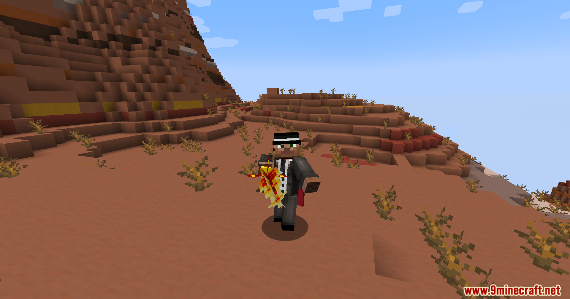 Player holding a fiery magical sword in the badlands