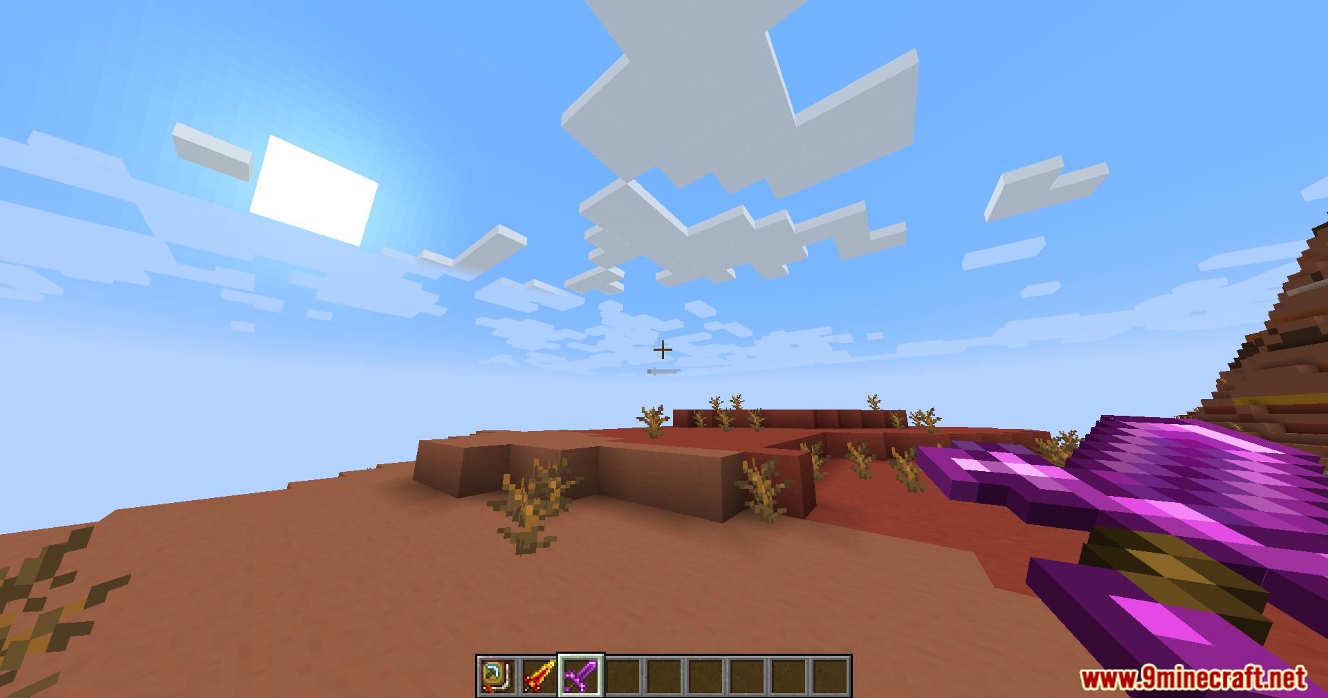 First-person view of a magical weapon in the badlands