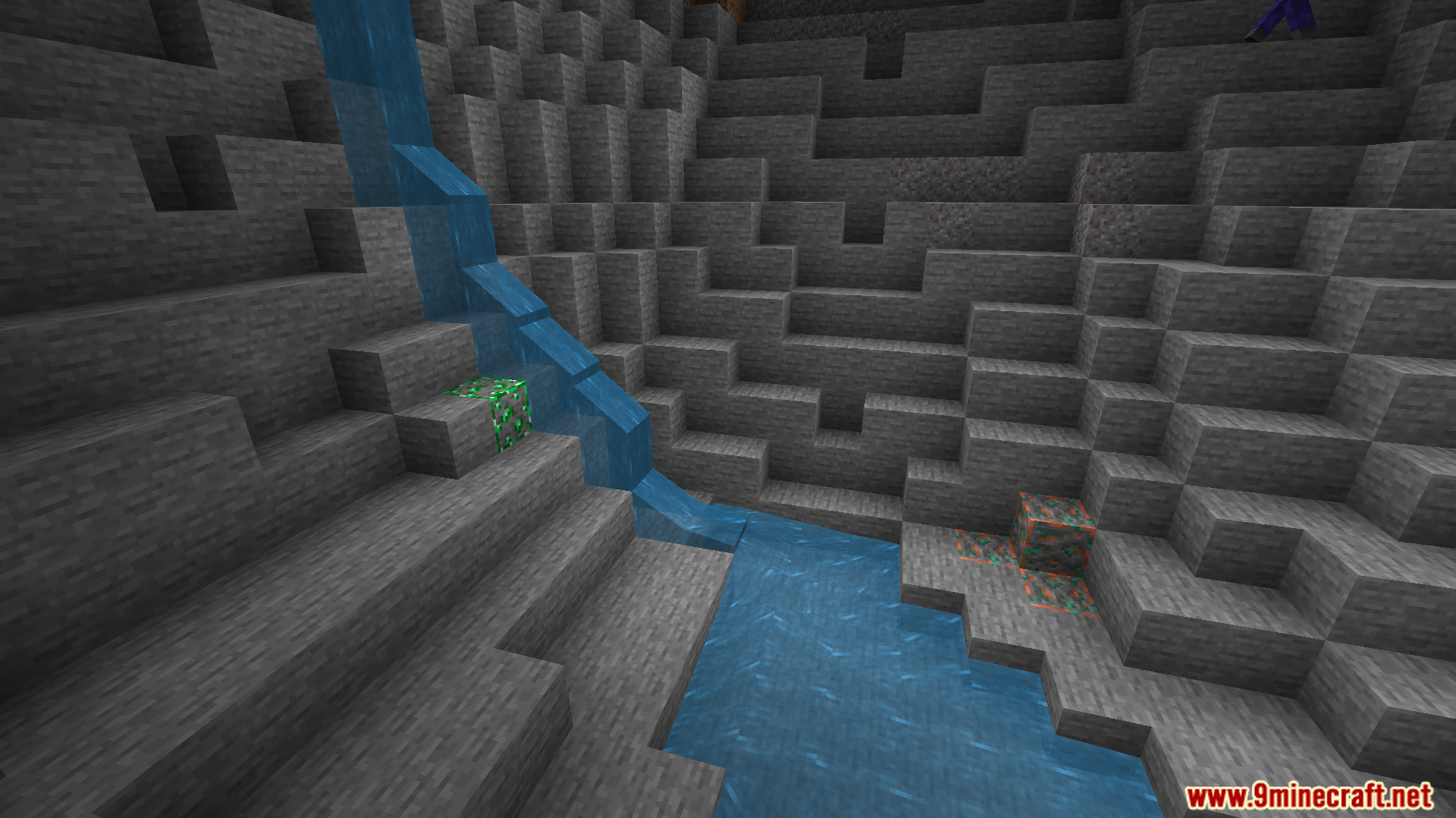 Glowing ores light up a dark cave next to a stream