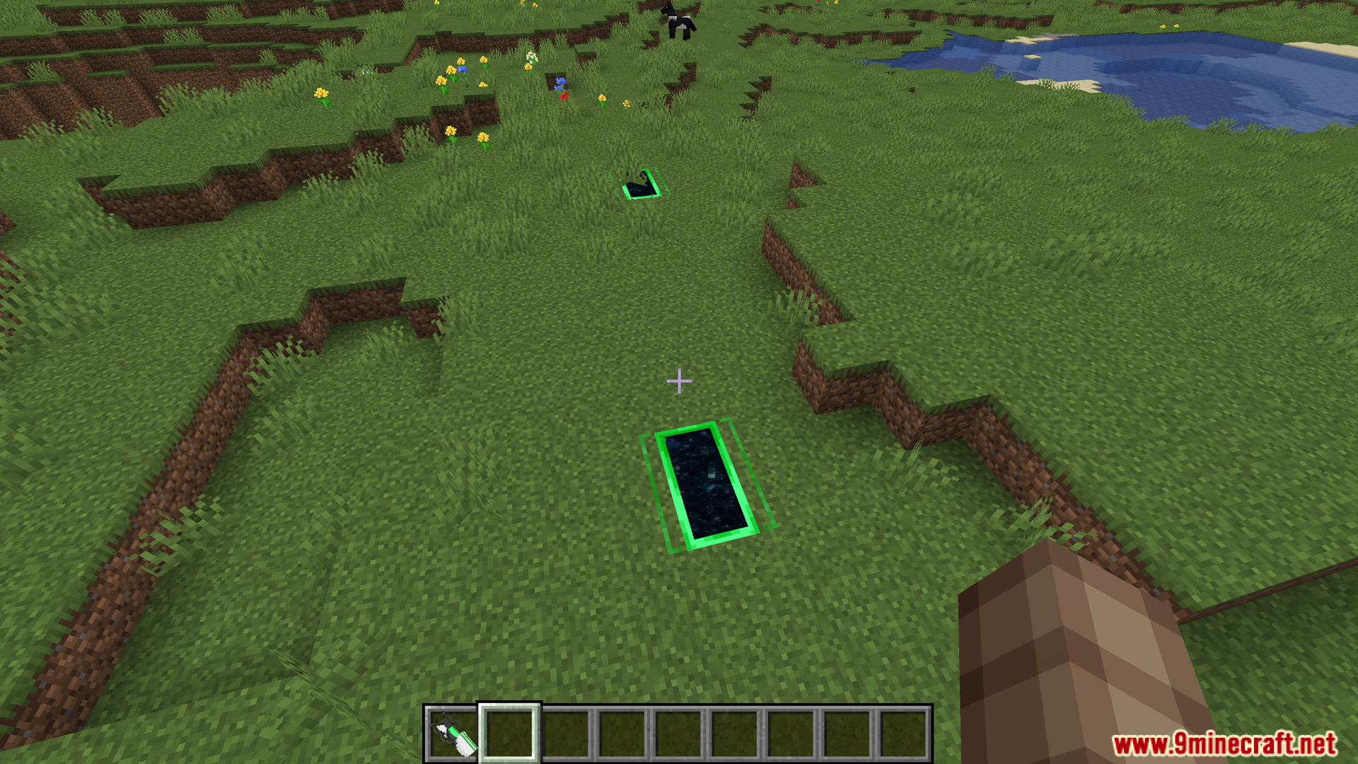 Several green portals placed on a grassy hill
