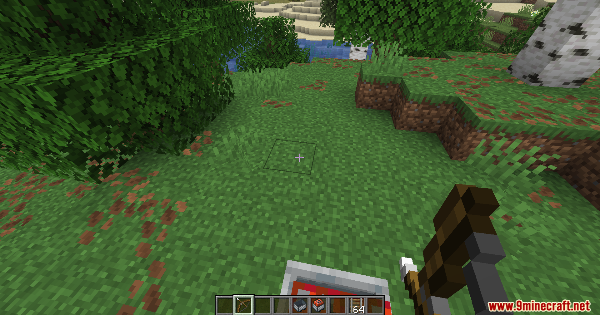 Player holding a crossbow in a grassy area