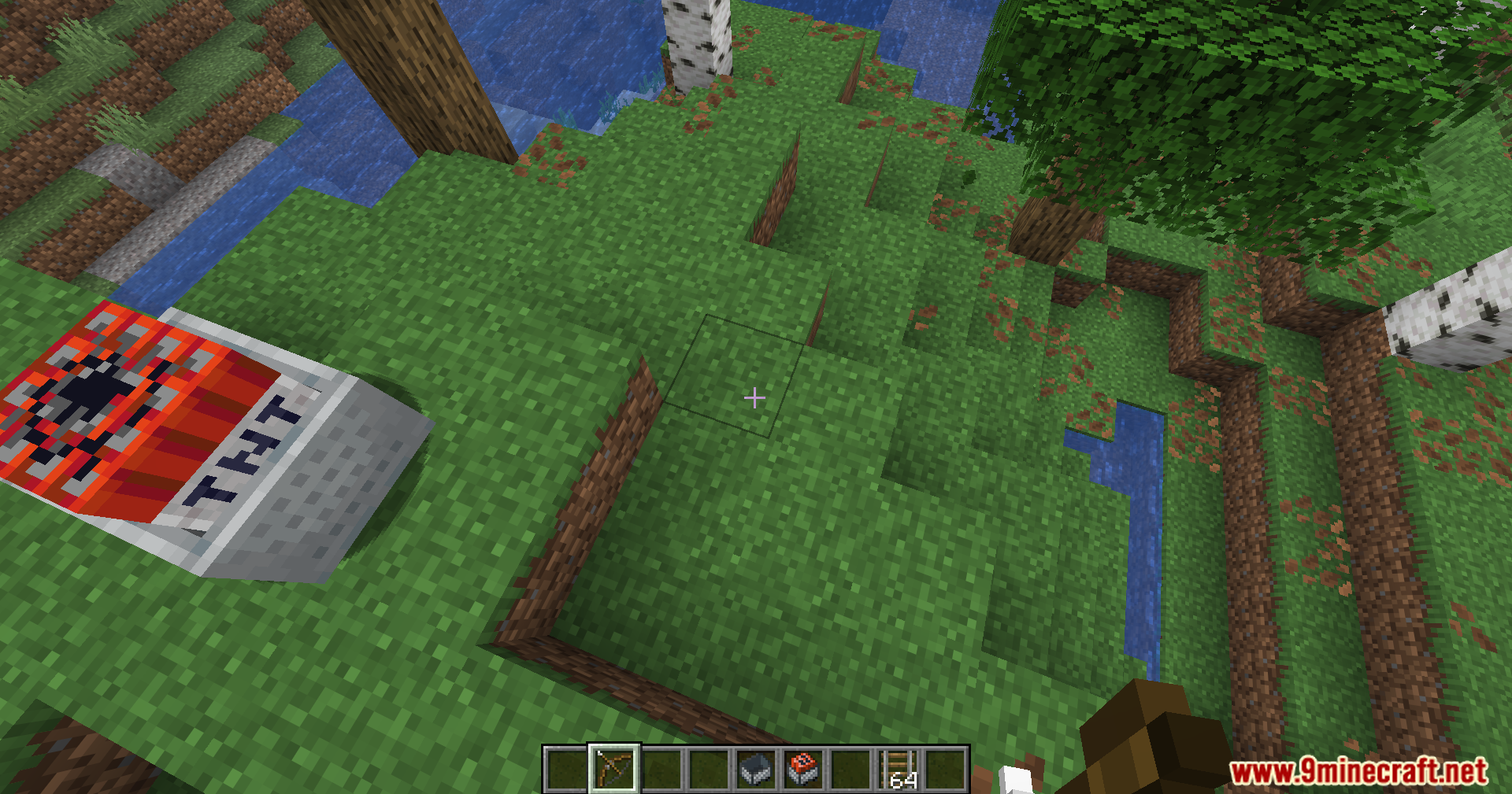 A TNT minecart resting on a grassy hill