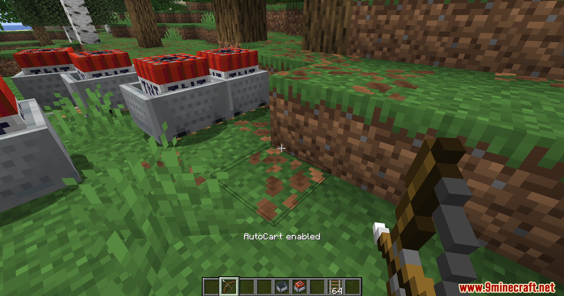 Player aiming a bow near a row of TNT minecarts