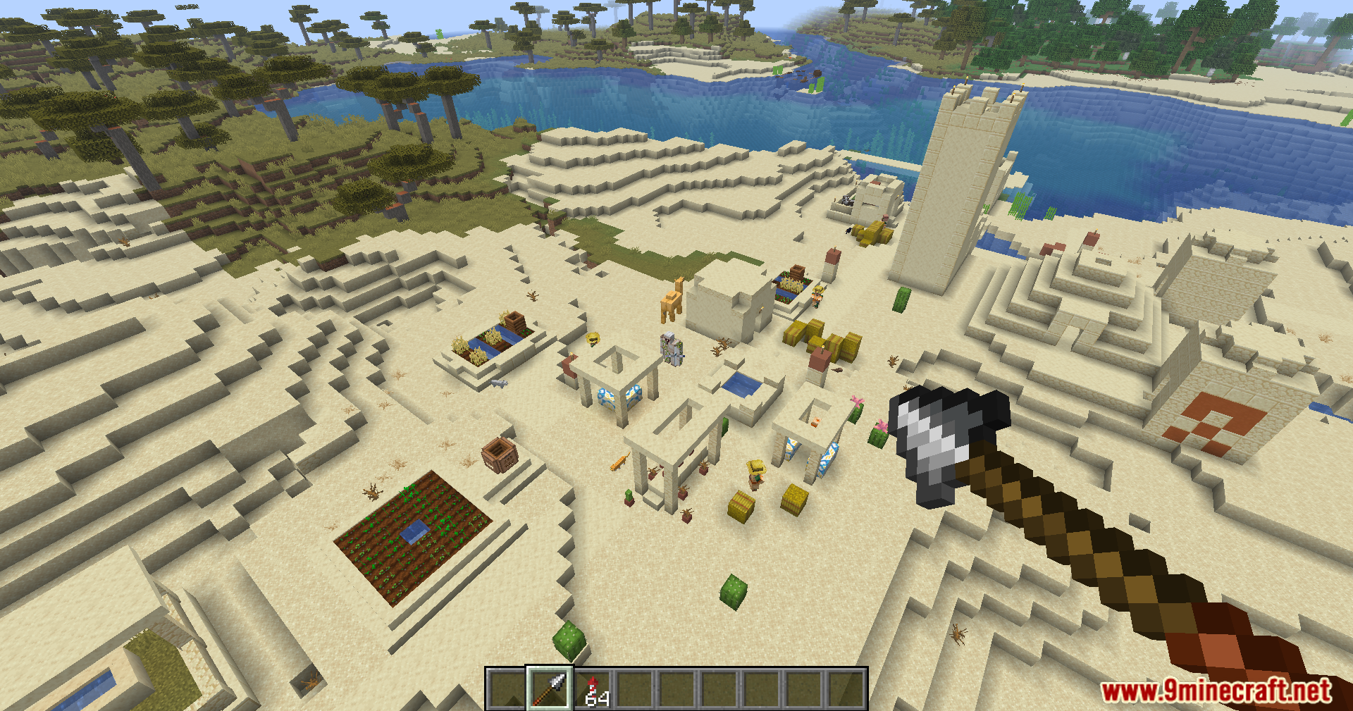 Player holding an Auto Spear over a desert village