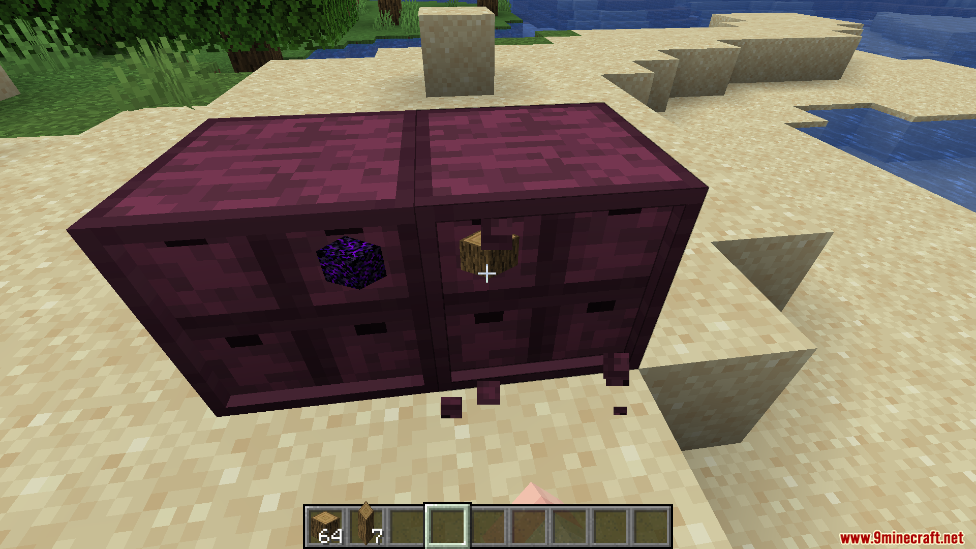 BBL Fixes Mod Screenshot 11 Two crimson storage drawers placed on a sandy beach in Minecraft