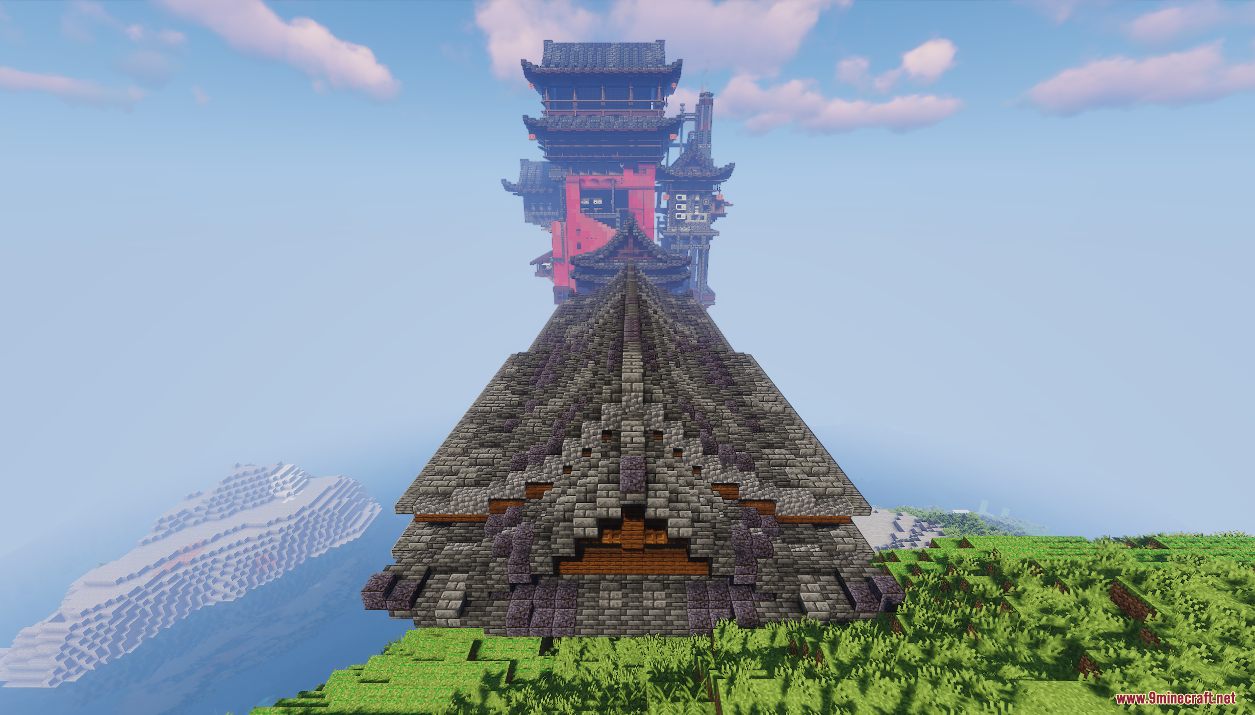Long dark tiled roof leading towards the distant red tower