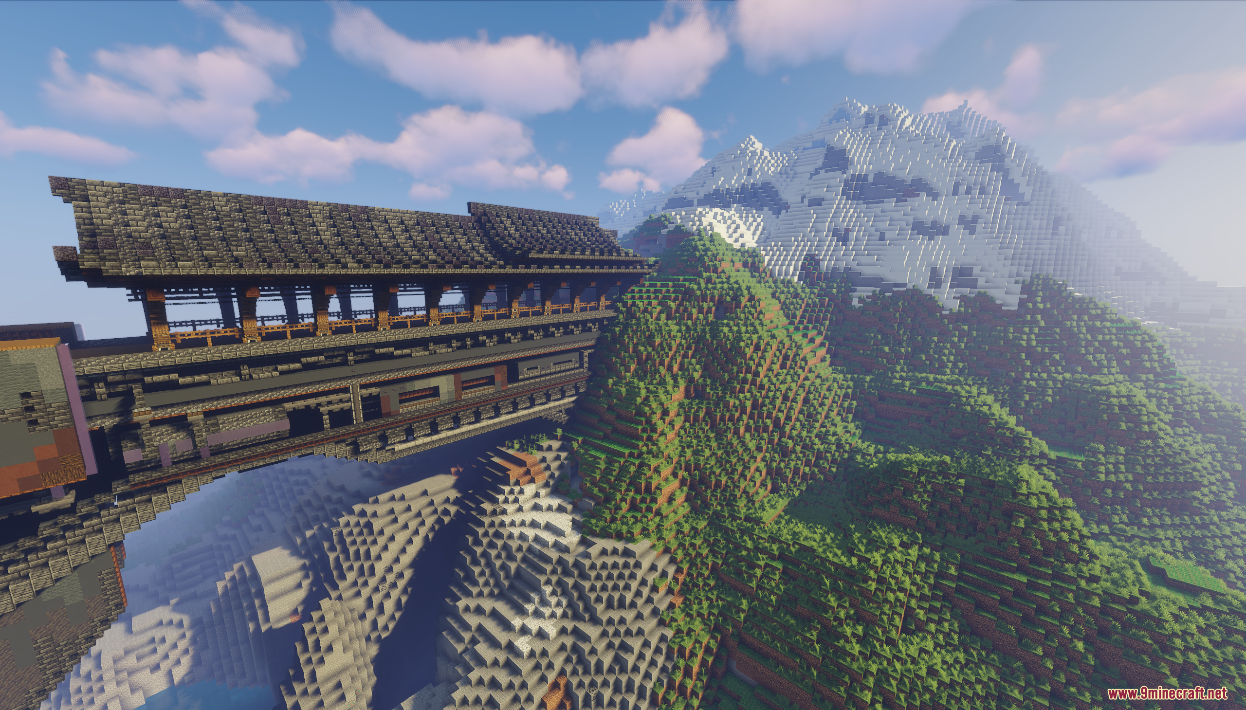 Covered wooden bridge connecting to a large snowy mountain