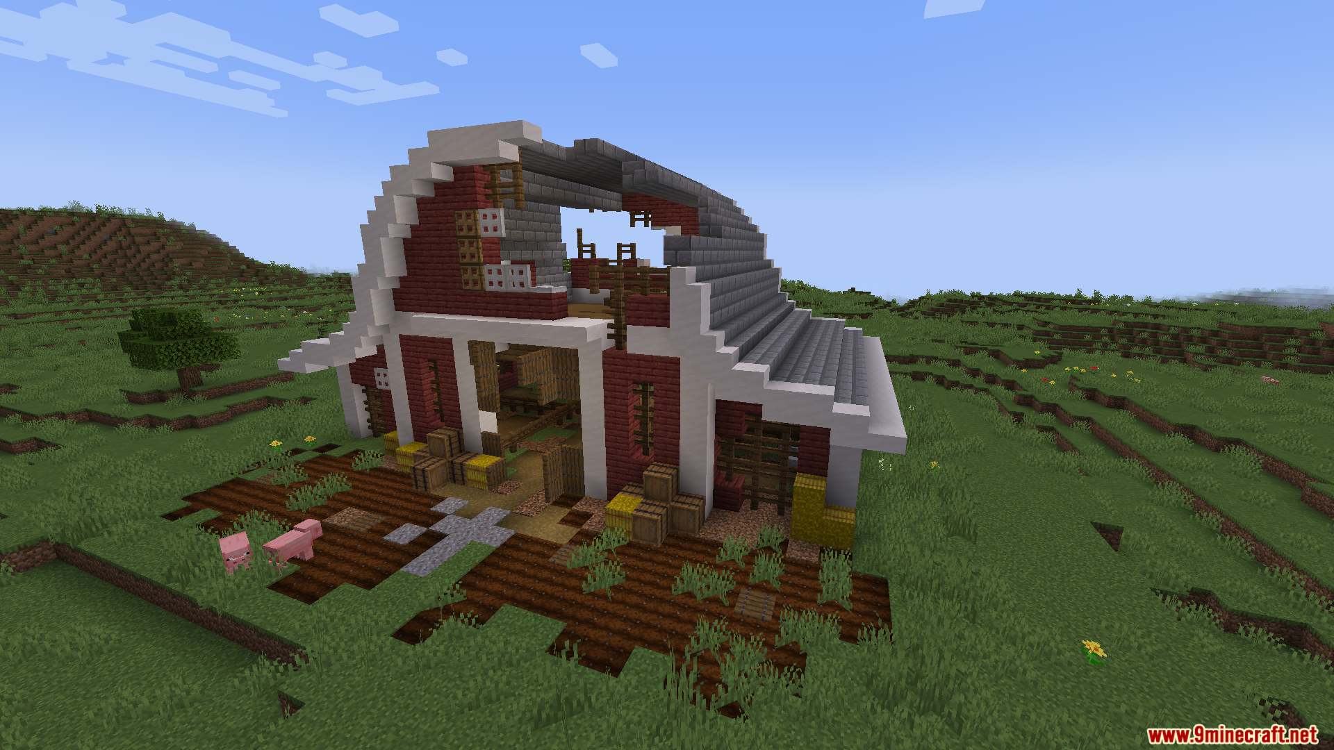A large, dilapidated red barn with a curved roof