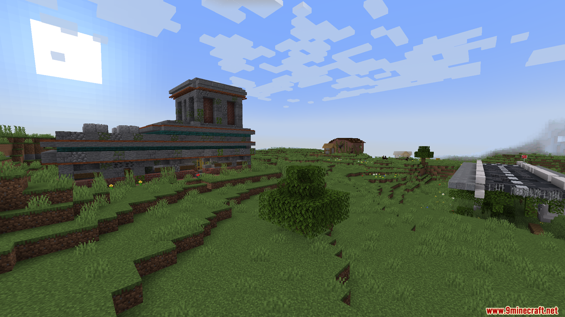 A large, ancient stone ruin on a grassy hillside