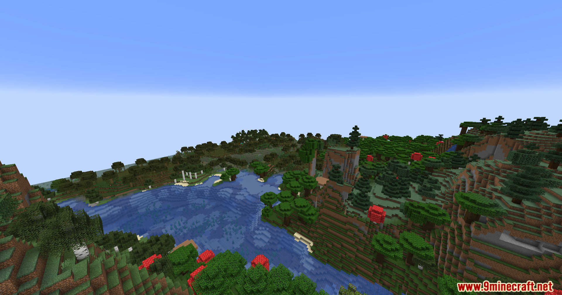 Overlooking a winding river next to a dense roofed forest