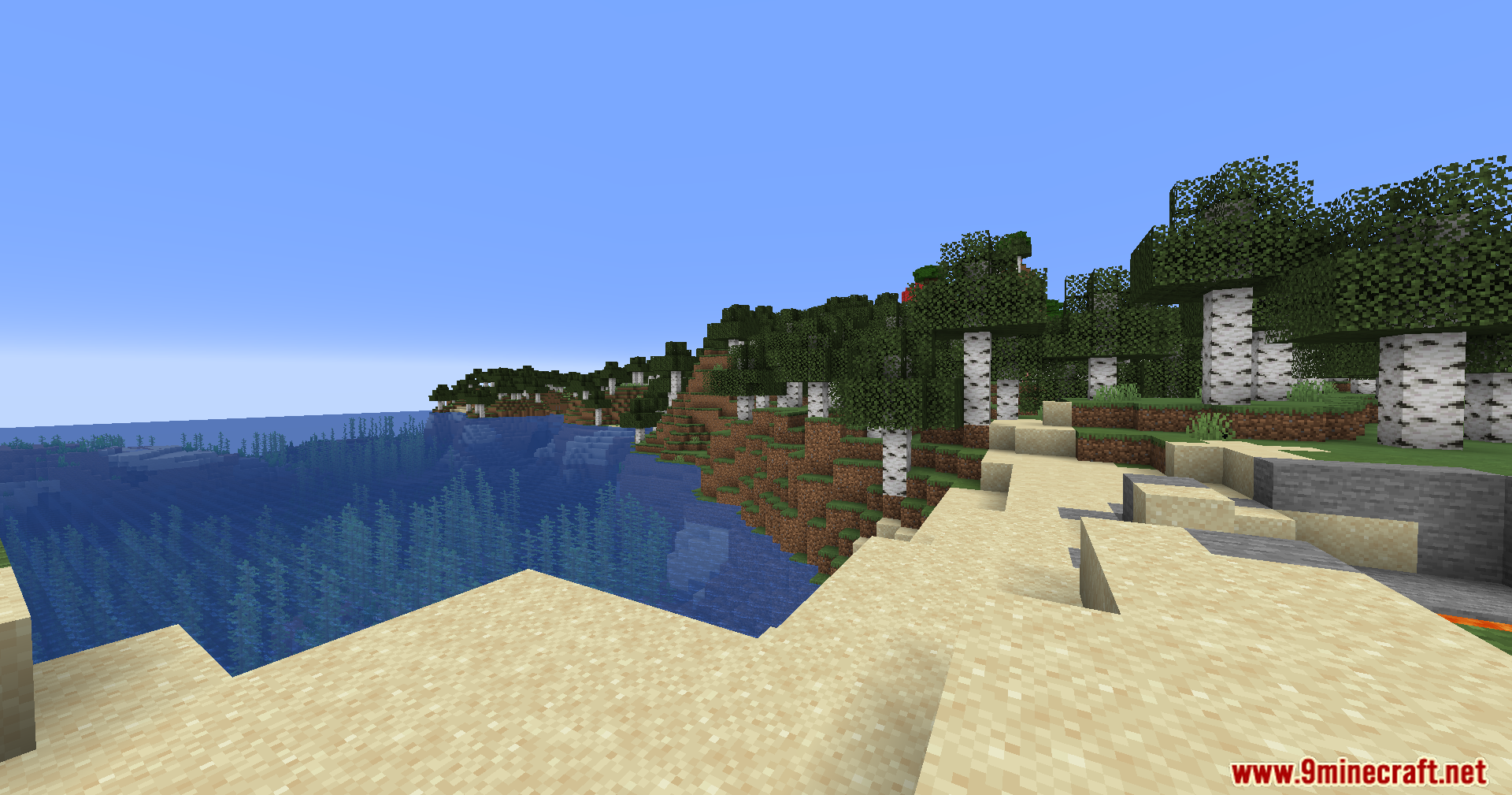 A sandy beach next to a clear blue ocean