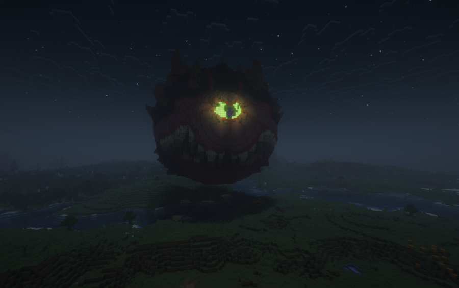 Large red demon statue with a glowing green eye hovering in the sky