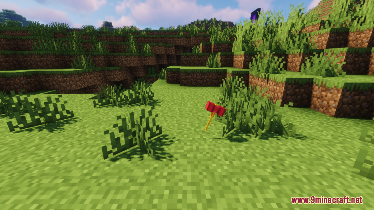 The custom red and yellow hammer item dropped on the grassy ground