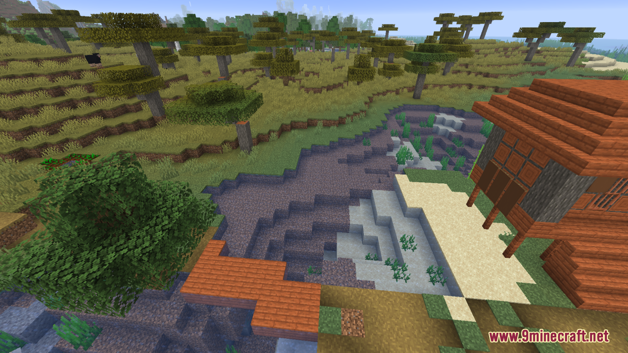 A clear water pond next to a savanna biome