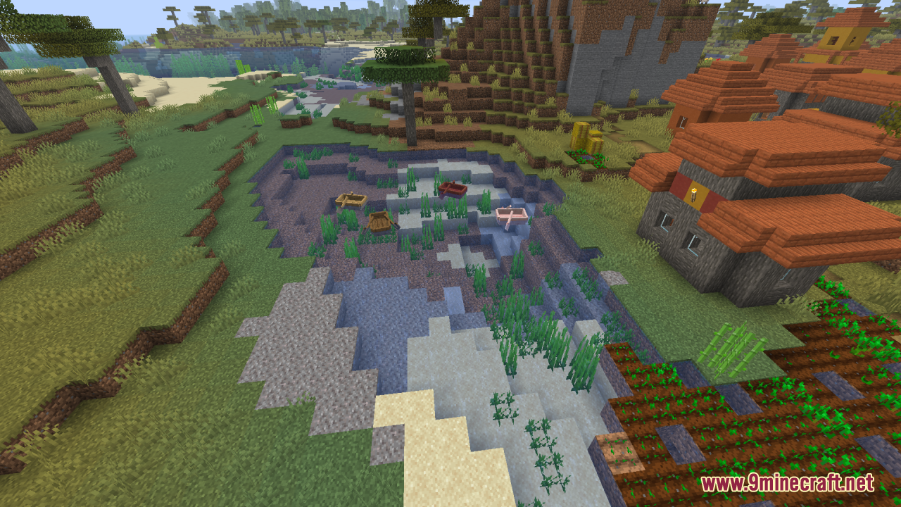 A village by a clear, shallow river with boats