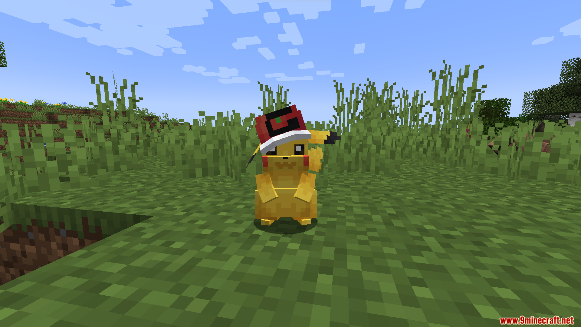 The hatted Pikachu stands among some tall grass
