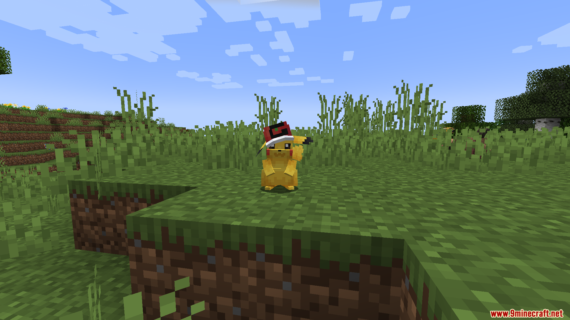 A Pikachu with a cap on a small grassy hill