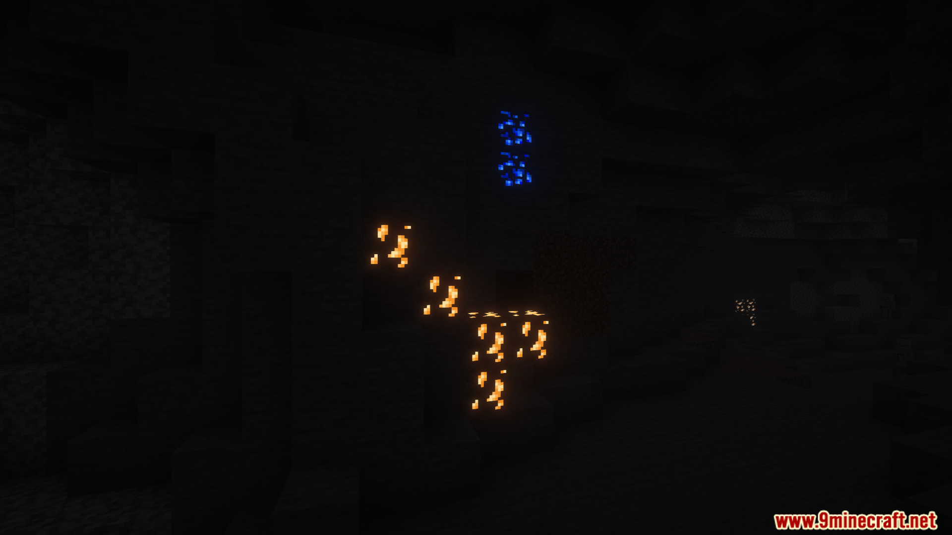Glowing blue and gold ores light up a dark cave